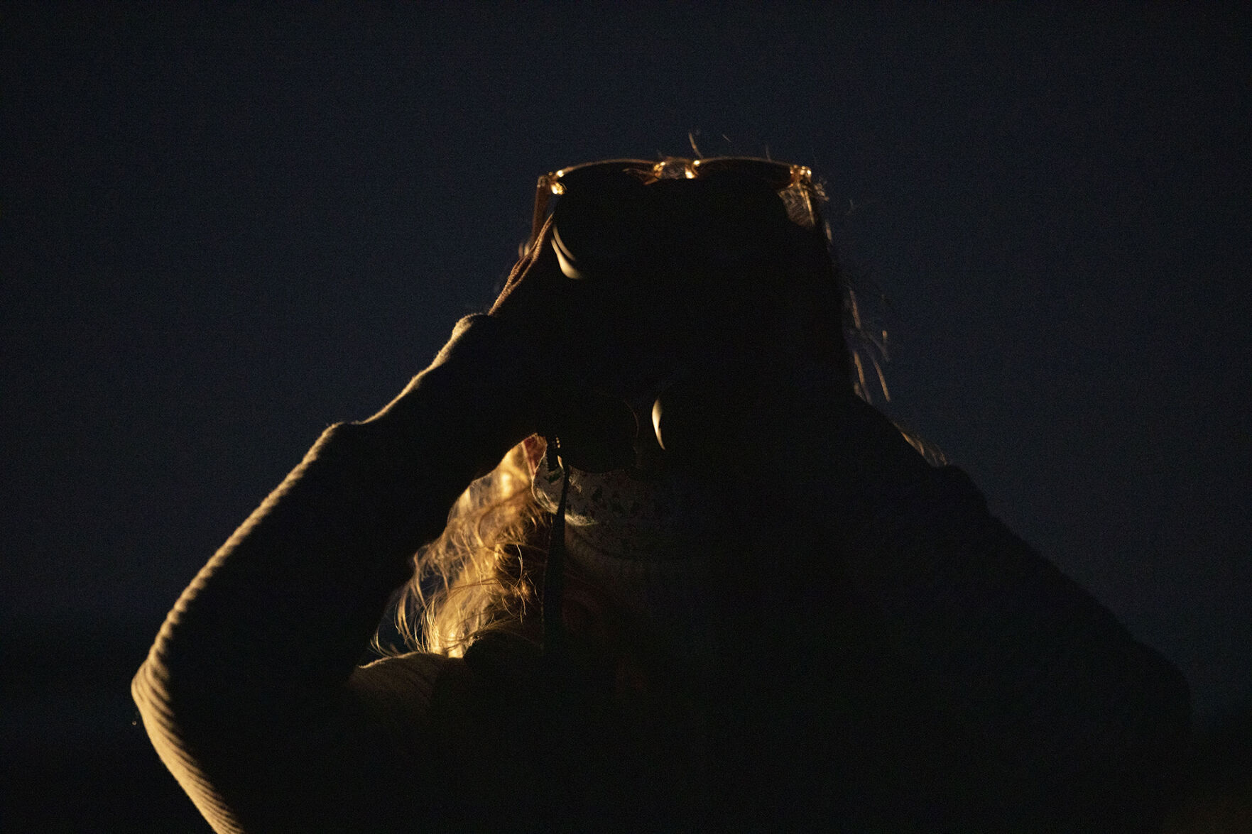 Gwendolyn Griffin looks through binoculars to view the ‘Great’ Conjunction of Jupiter and Saturn at the Garden of the Gods Park in Colorado Springs on Monday, Dec. 21, 2020. According to NASA's website, it has been nearly 400 years since the planets passed this close to each other and nearly 800 years since the alignment of Saturn and Jupiter occurred during the night. The last conjunction happened during the day 400 years ago and was not visible. (Chancey Bush/ The Gazette) (Chancey Bush/ The Gazette)