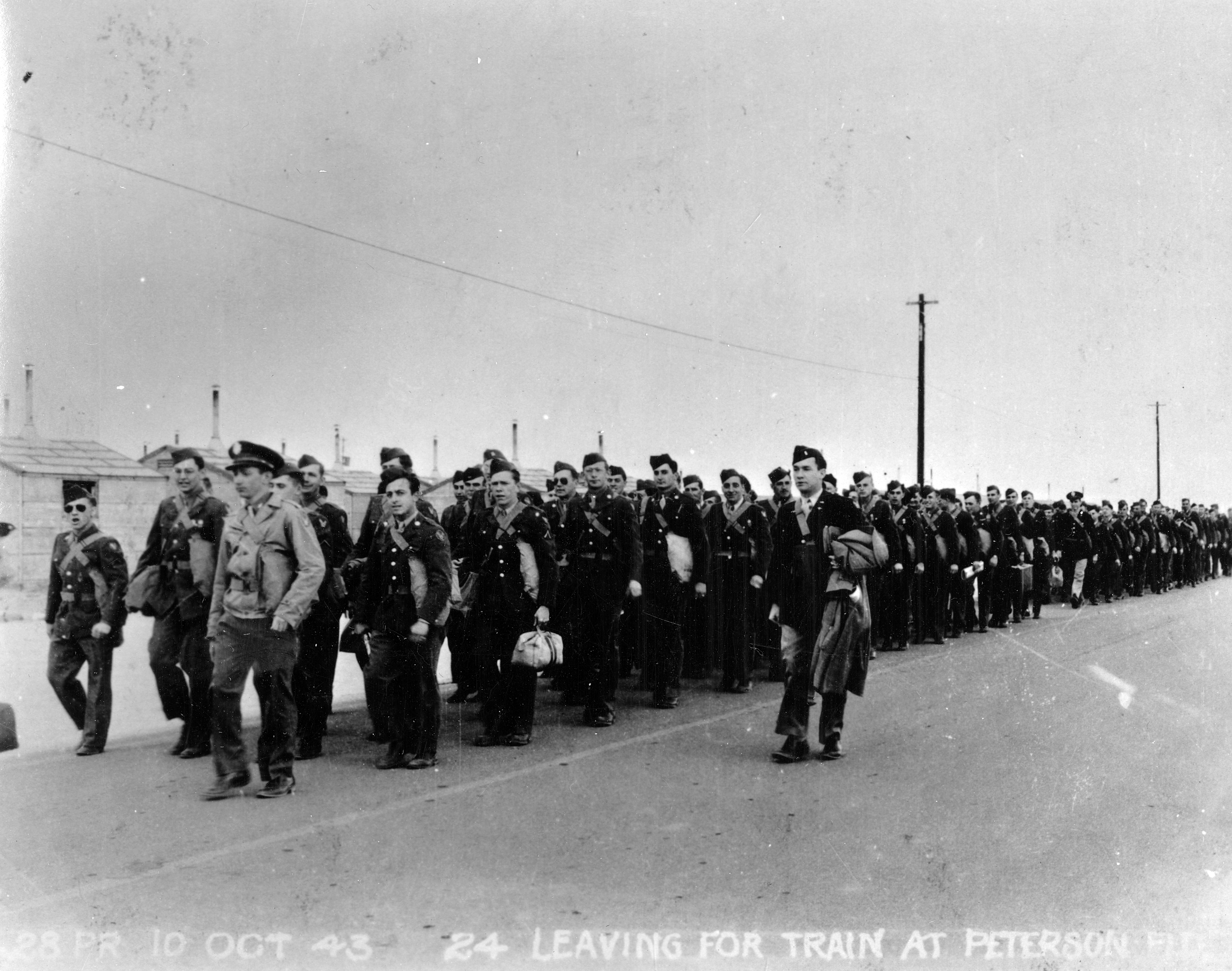 Written on the bottom of this print: “28PR / 10 Oct 43 / 24 / Leaving for train at Peterson Fld.” Peterson Field began as Colorado Springs Army Air Base. In December 1942, base officials changed the name to Peterson Army Air Base to honor a fallen airman, 1st Lt. Edward J. Peterson, according to a history posted on Peterson Air Force Base’s website. Peterson was the first Coloradan killed in a flying accident at the airfield. The base was frequently referred to as Peterson Field or simply Pete Field. It was renamed Peterson Air Force Base in 1976.