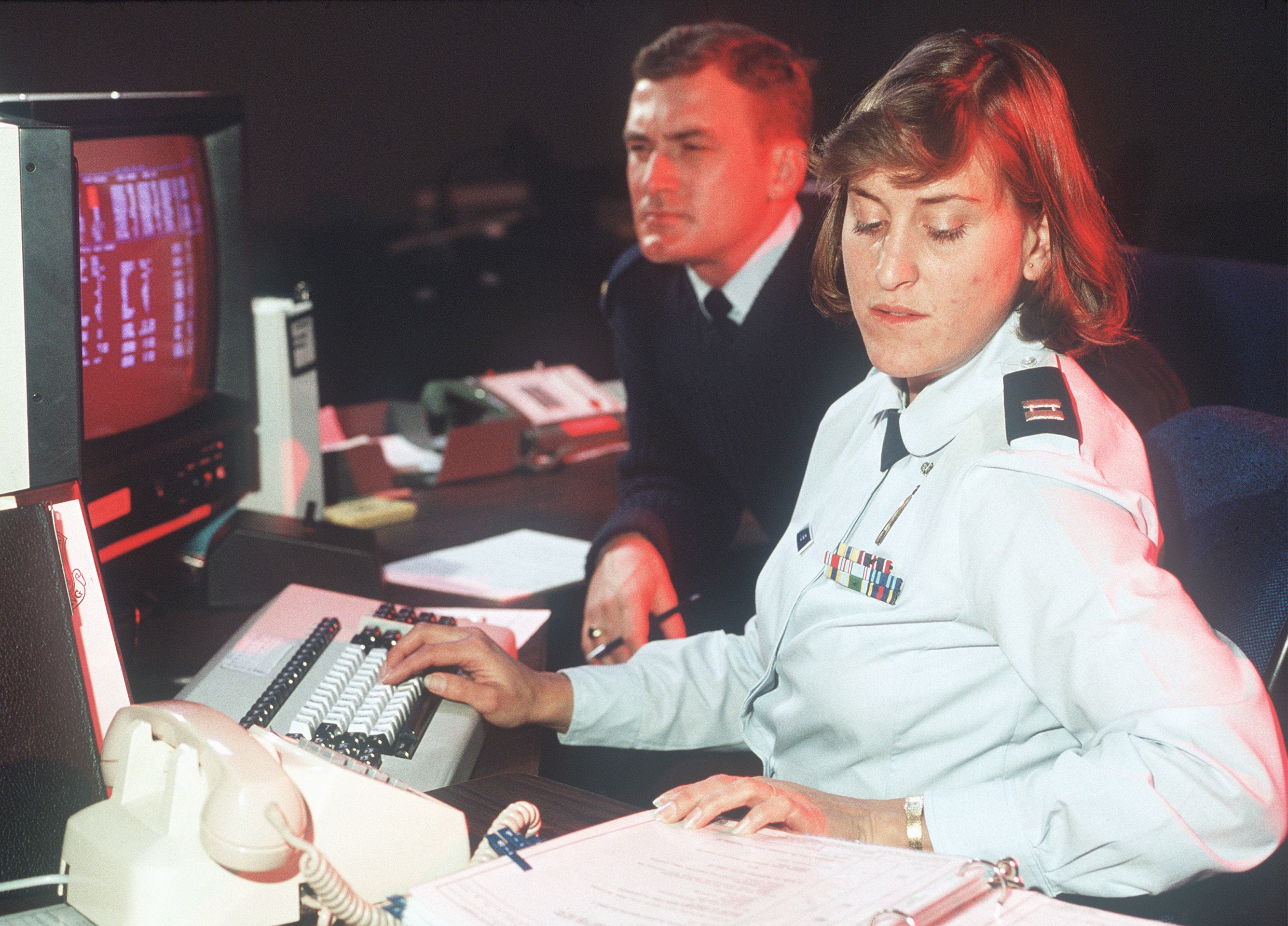 Captain Patricia K. Coomber and 2nd Lieutenant Kevin J. Carter monitor functions of orbiting Global Positioning System satellites on a console in Colorado Springs in this undated Air Force photo. The systems look old, now, but they were cutting-edge in 1991 and played a key role in American success in the Persian Gulf War. (Air Force Photo) (Staff Sergeant Scott Stewart)