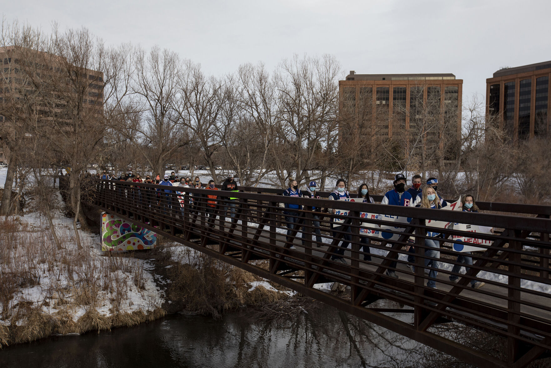 Students, parents and coaches walk to the office of the Colorado Department of Public Health and Environment during the LetCOPlay protest in Glendale, Colo., on Thursday, Dec. 17, 2020. Around 70 students, parents and coaches participated in response to the CDPHE postponement of high school winter sports. (Chancey Bush/ The Gazette) (Chancey Bush)