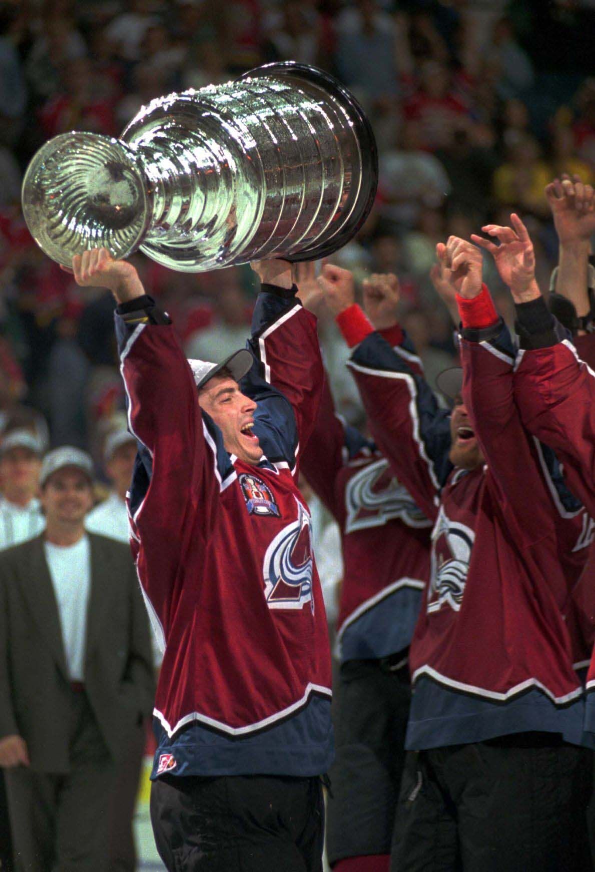 Avalanche team captain Joe Sakic lifts the Stanley Cup during the celebration of the team's four-game sweep of the Florida Panthers for the 1996 championship. (Gazette file photo)