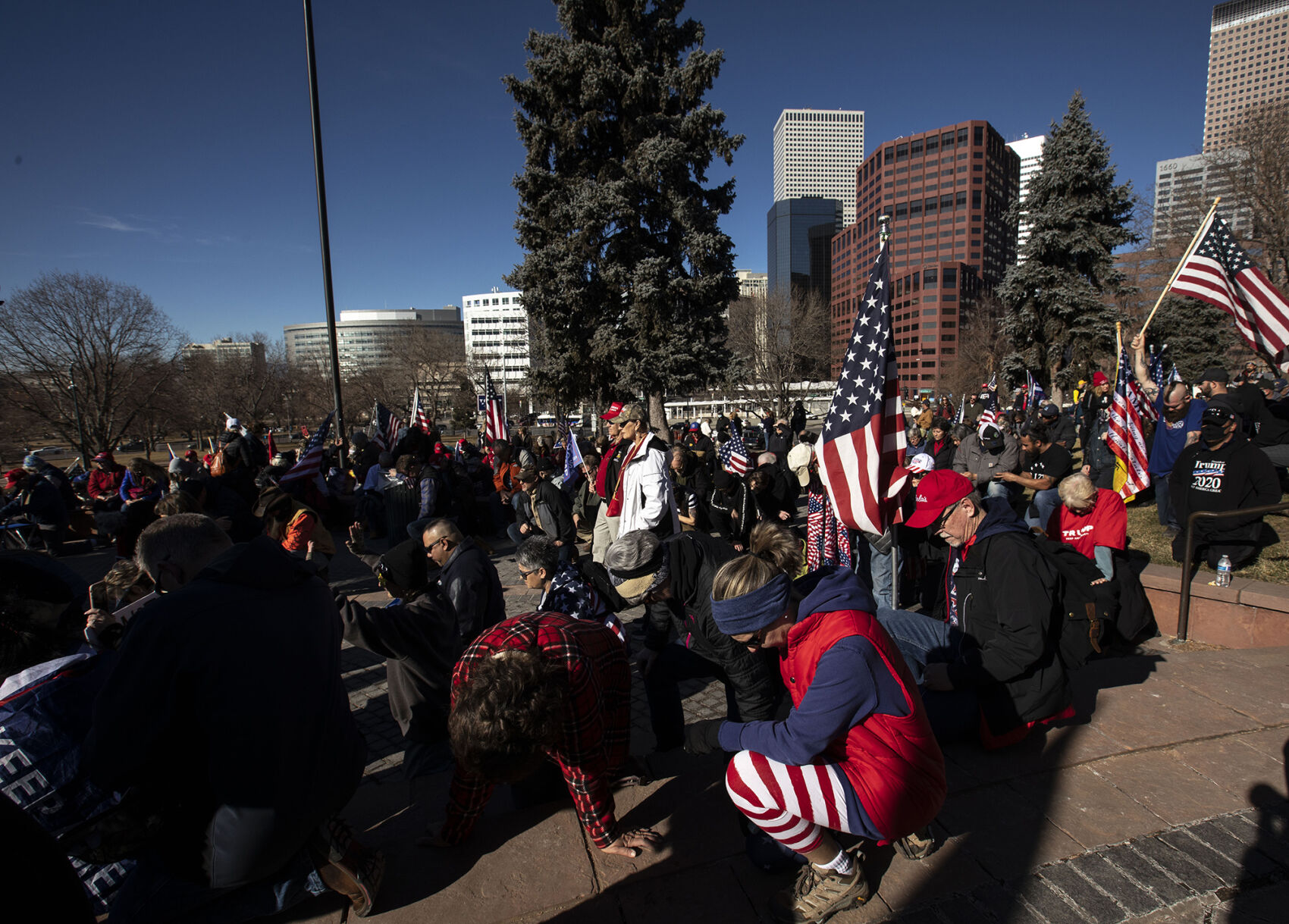 Protesters kneel during a prayer during the 