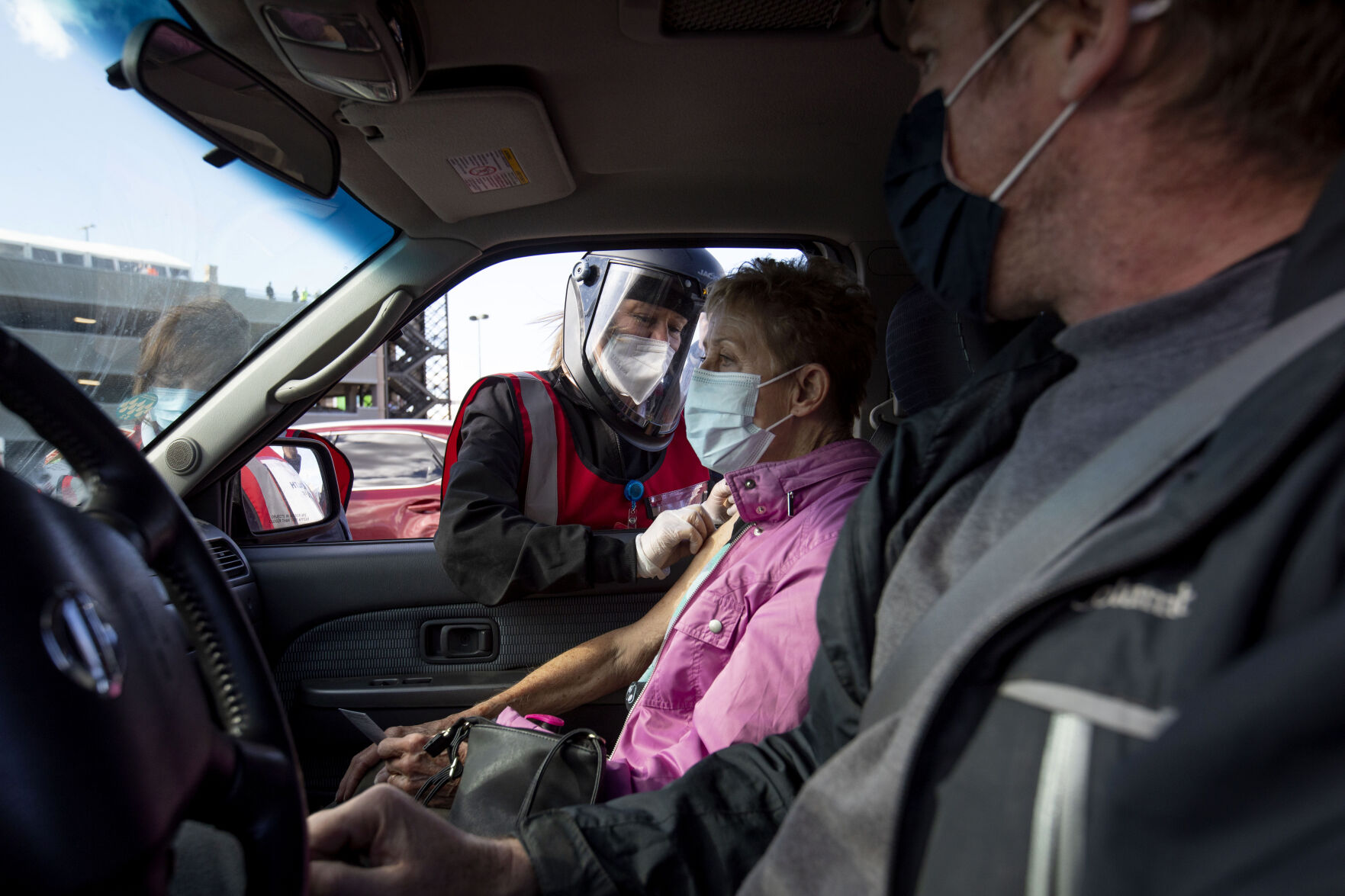 Janet Zietz, 81, of Lakewood receives her COVID-19 vaccine administered by UCHealth RN Karen Nerger during UCHealth's large-scale COVID-19 vaccination drive-thru site at the Coors Field parking lot in Denver Colo., on Saturday, Jan. 30, 2021. The vaccination site is the largest in the state with 10,000 older people expected to be vaccinated through the weekend. (Chancey Bush/ The Gazette) (Chancey Bush/ The Gazette)