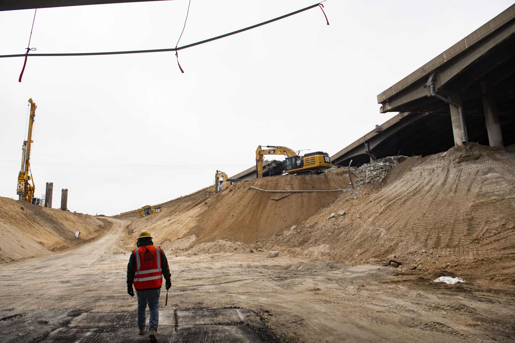 Crews demolish an onramp for the Interstate 70 viaduct as a worker walks out of the westbound tunnel of the Central 70 project Monday, Nov. 9, 2020, through the Denver neighborhoods of Globeville/Elyria-Sawnsea. (The Gazette, Christian Murdock) (Christian Murdock/The Gazette)