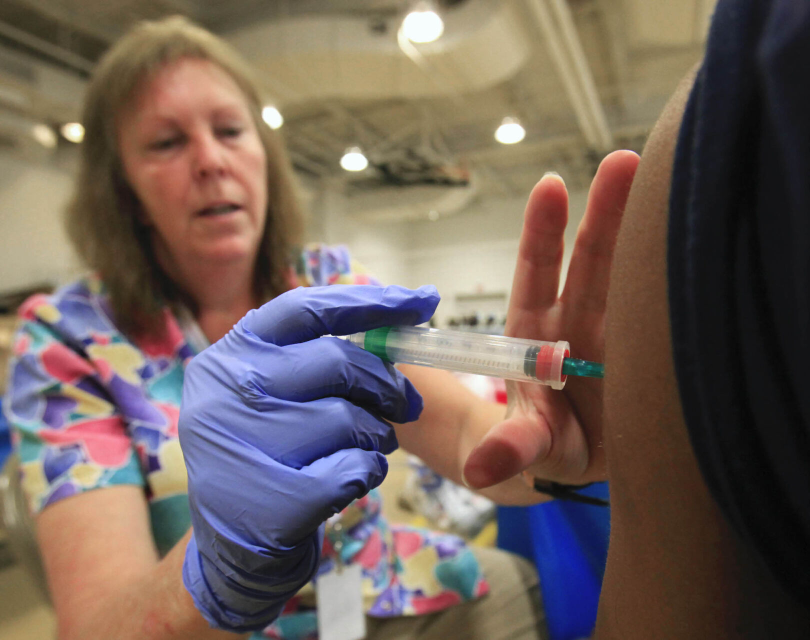 Nurse Susan Peel gives a whooping cough vaccination to a student at Inderkum High School in Sacramento, Calif. (Associated press file)
