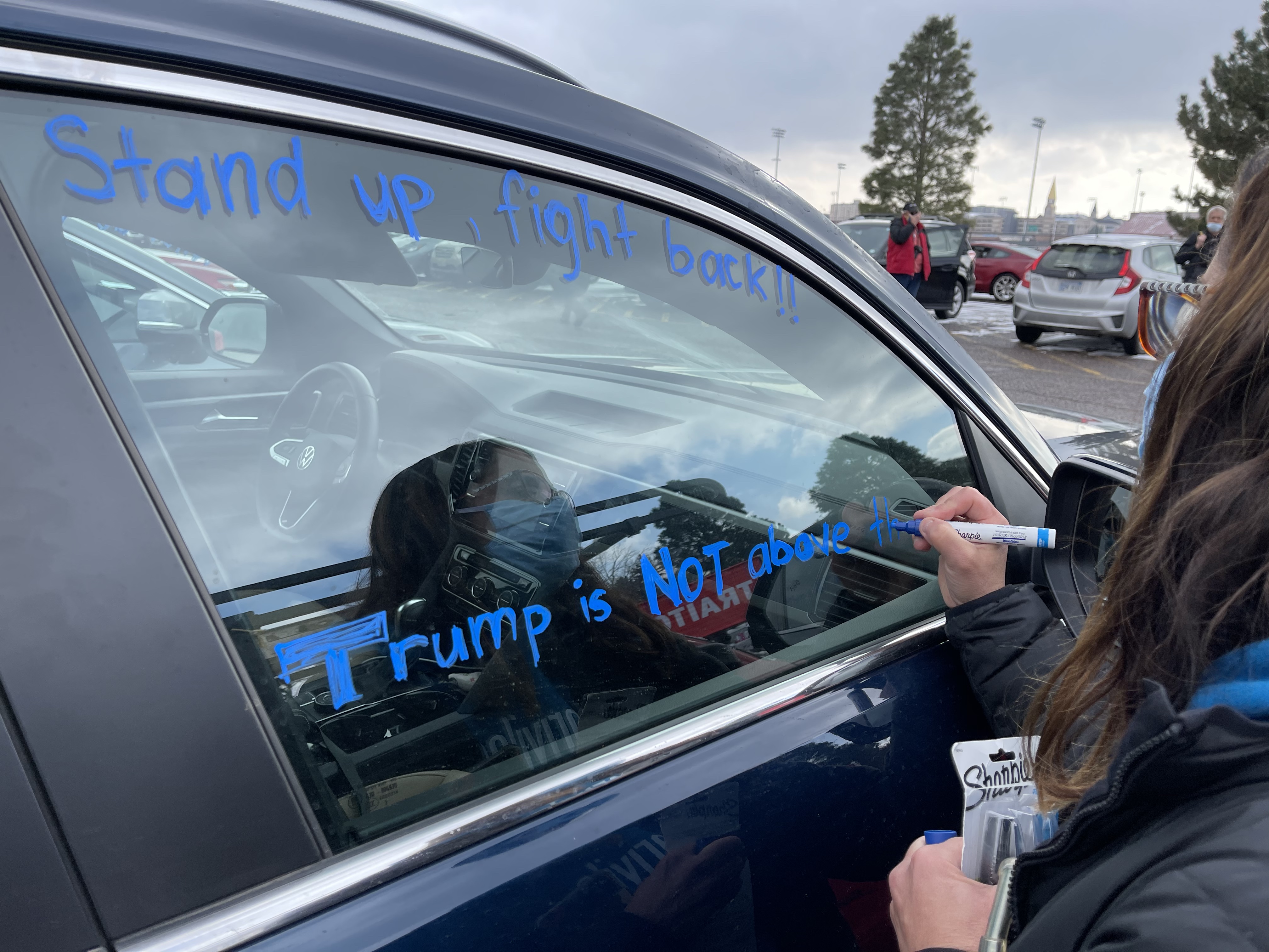 Erin Lackore of Littleton writes a phrase for others to see during the Remove Trump Now Car Rally on Jan. 10, 2021, in the parking lot of South High School in Denver. (DavidMullenBreaking News Reporterdavid.mullen@gazette.comhttps://secure.gravatar.com/avatar/349fcb3ec304c9bbf2b50a05578938e7?d=mm&r=g)