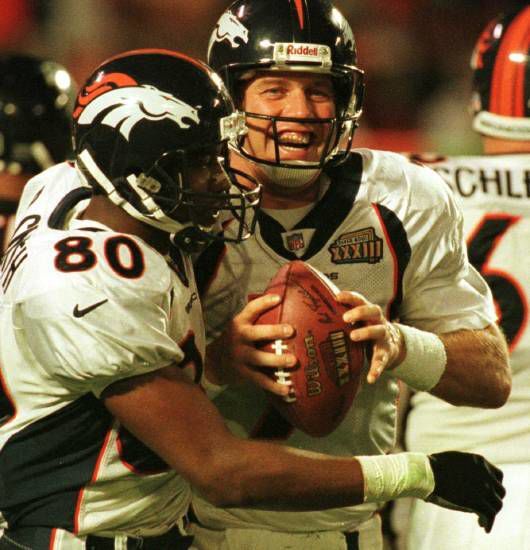 John Elway and Rod Smith celebrate after Elway's fourth-quarter touchdown in the Broncos 34-19 Super Bowl win over Atlanta. (Gazette file) (Gazette File photo)