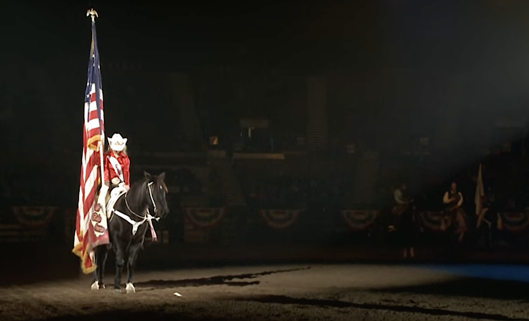 Before each rodeo during the National Western Stock Show in Denver, riders present the American flag. (Courtesy of the National Western Stock Show)