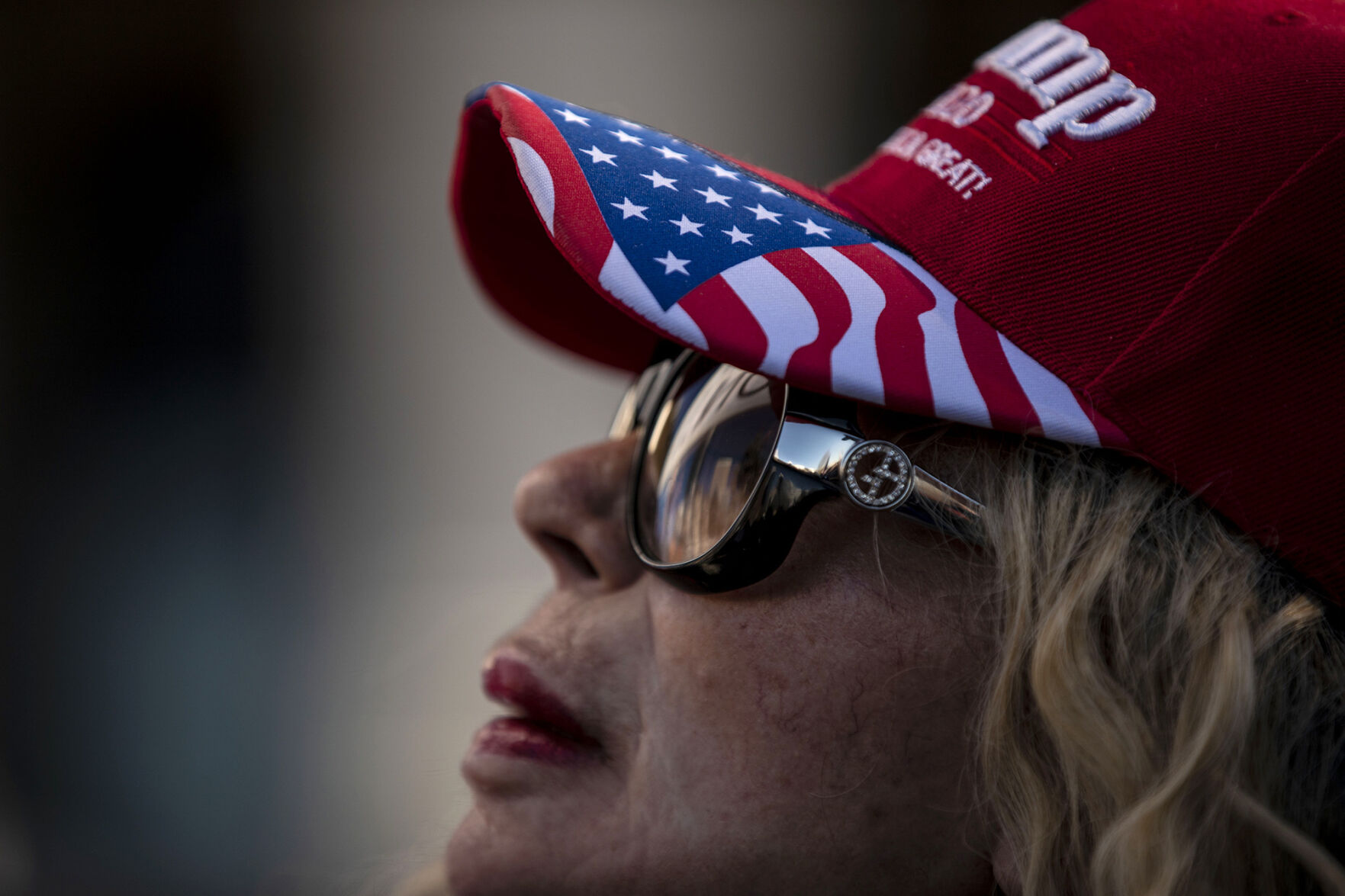 Hetty Hennessey, from Boulder, listens to speakers during the 