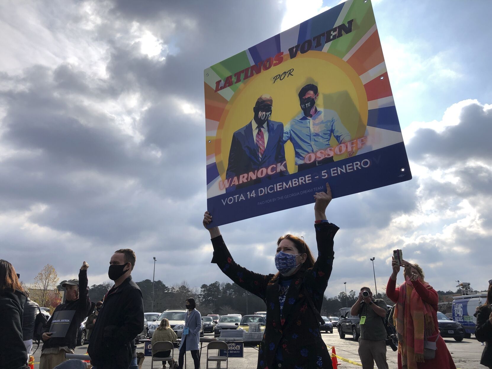 A supporter holds up a sign calling on Latinos to vote for Democrats Raphael Warnock and Jon Ossoff during a rally for Ossoff and former U.S. Secretary of Housing and Urban Development Julian Casto in Lilburn, Ga., Monday, Dec. 7, 2020. The rally was part of an effort to register and mobilize voters in Georgia's growing Latino population for the two Democratic candidates in the Georgia's twin Jan. 5 Senate runoffs that will determine which party controls the U.S. Senate. (JoeyBunchjoey.bunch@coloradopolitics.comhttps://secure.gravatar.com/avatar/66505e98f9e3fed10e6a3b9a1fc4ca22?d=mm&r=g)