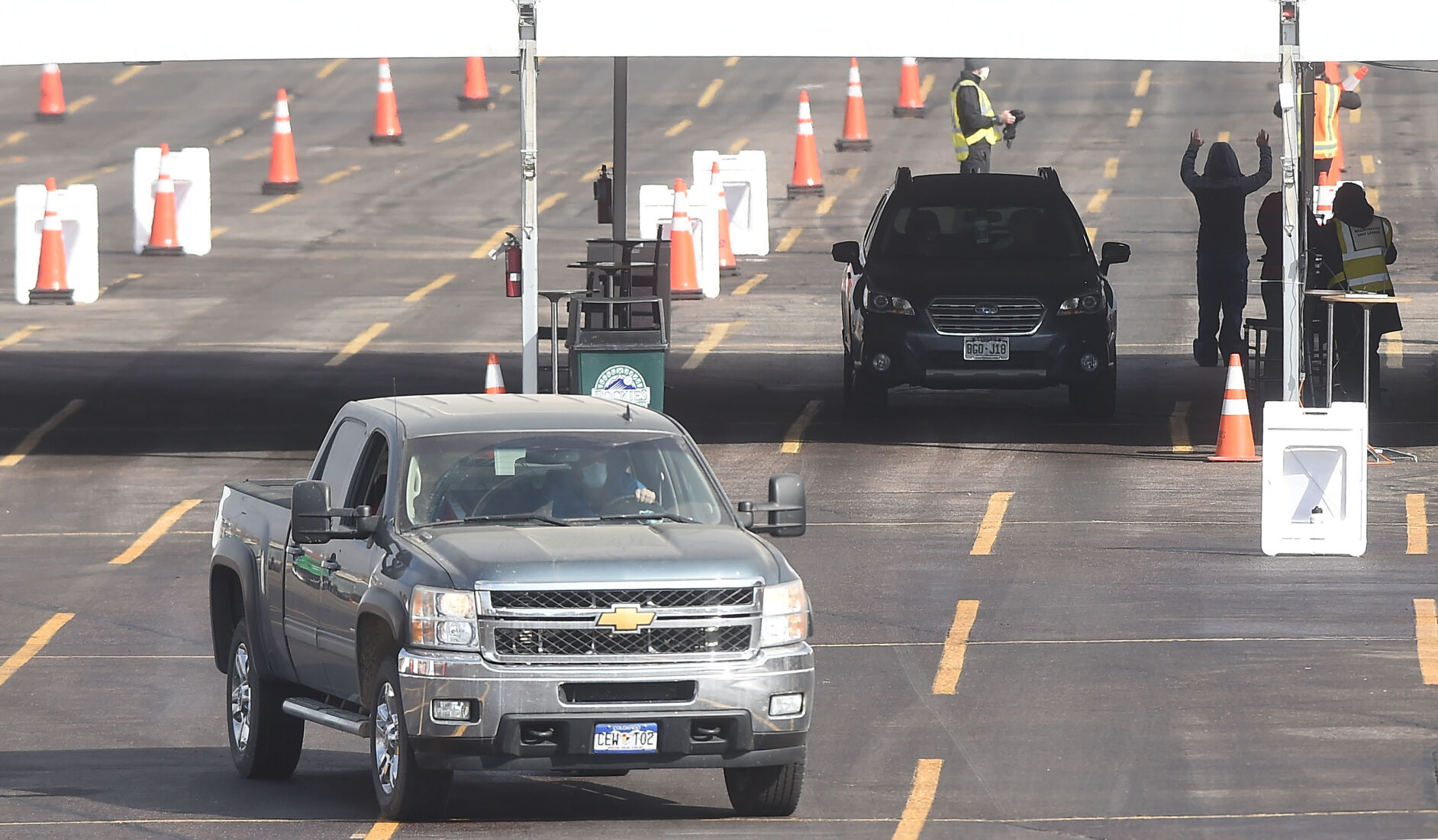 During a test run for giving mass vaccinations, those receiving vaccines stop to register and then head to individual stations on Sunday, Jan. 24, 2021. About 1000 Seniors received their vaccines that day in the parking lot of Coors Field from the comfort of their vehicles. UCHealth hopes to give about 10,000 vaccinations this weekend at the same location. (Photo by Jerilee Bennett, The Gazette) (JERILEE BENNETT)