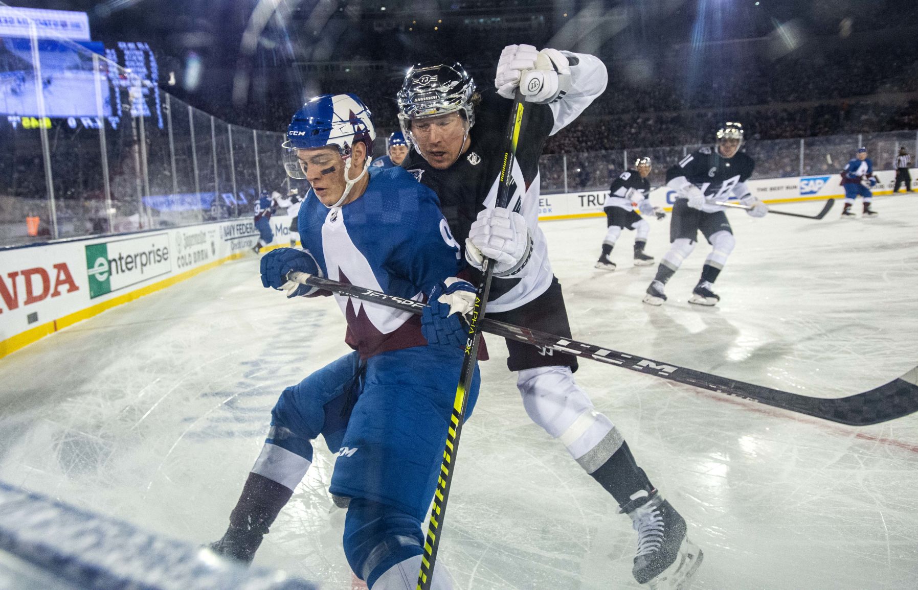 Colorado Avalanche left wing Andre Burakovsky (95) battles Los Angeles Kings right wing Tyler Toffoli (73) on the boards during the first period Saturday, Feb. 15, 2020, at Falcon Stadium on Air Force Academy as part of the NHL Stadium Series. (The Gazette, Christian Murdock) (CHRISTIAN MURDOCK/THE GAZETTE)