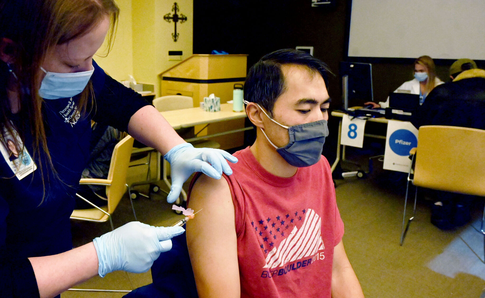 Healthcare worker David Lin gets a COVID-19 vaccine from Wendy Erickson at St. Francis Medical Center during a clinic at the hospital on Wednesday, Jan. 27, 2021. (Photo by Jerilee Bennett, The Gazette) (JERILEE BENNETT)