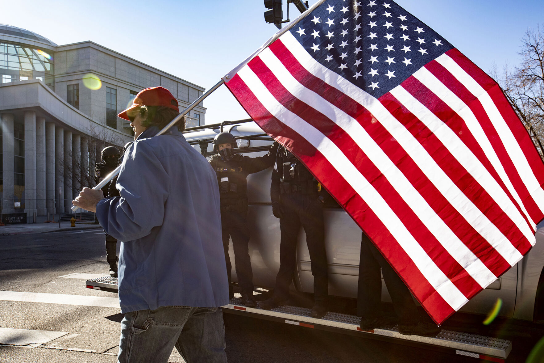A pro Trump protester walks past State Troopers during the 