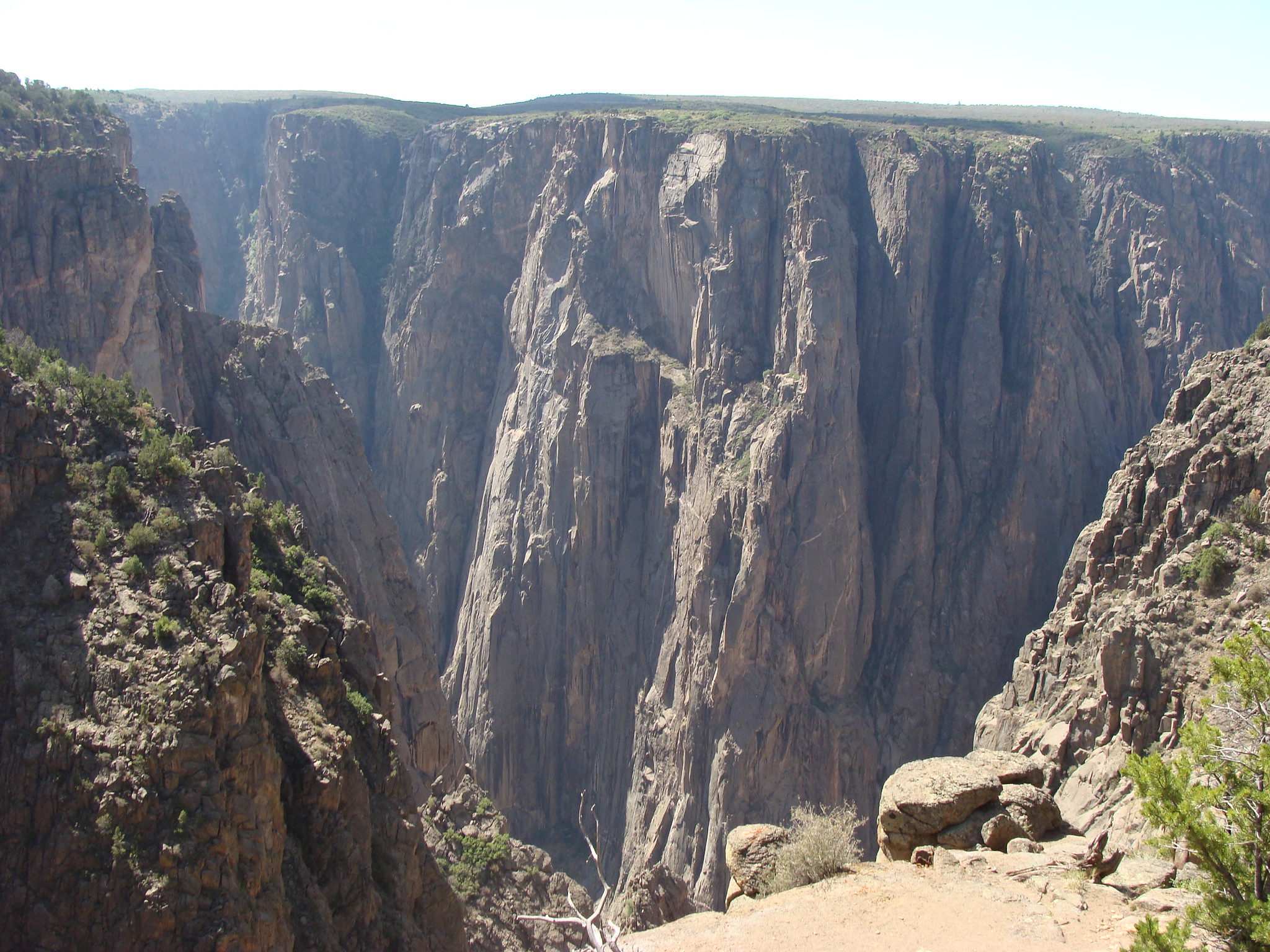 Features of Black Canyon of the GunnisonThe Precambrian metamorphic rock of Black Canyon is approximately 1.7 billion years old. For more than 2 million years, the Gunnison River has carved its way through the rock. The greatest depth of the canyon measures just over 2,720 feet from the rim to the river below.Credit: Jimmy Thomas (Flickr).