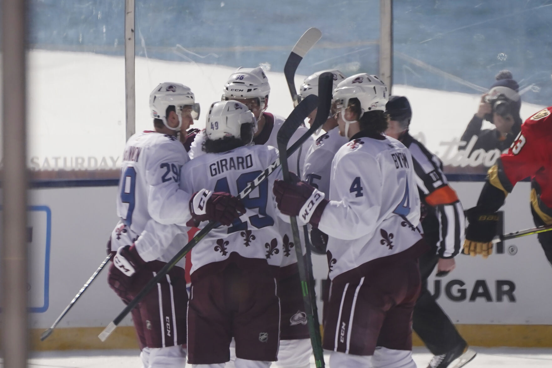 Colorado Avalanche defenseman Samuel Girard (49) is surrounded by his teammates after scoring during the first period against the Vegas Golden Knights, at the Outdoor Lake Tahoe NHL hockey game in Stateline, Nev., Saturday, Feb. 20, 2021. (Rich Pedroncelli - staff, AP)