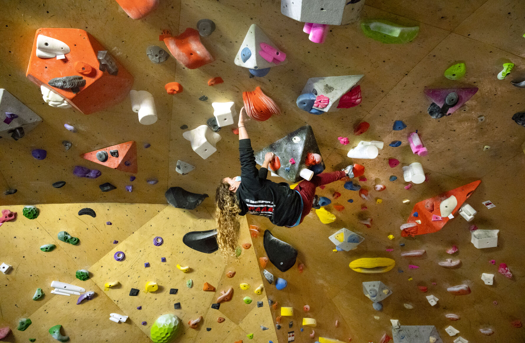 Tyler Youngwerth, 28, boulders in the climbing gym at Gearonimo Sports owned by Tyler and her parents. Youngwerth and her twin sister, Jesse, were nationally ranked rock climbers in 2012 when they were diagnosed with a rare condition known as Moyamoya and had to have brain surgeries. (photos by Christian Murdock, The Gazette)