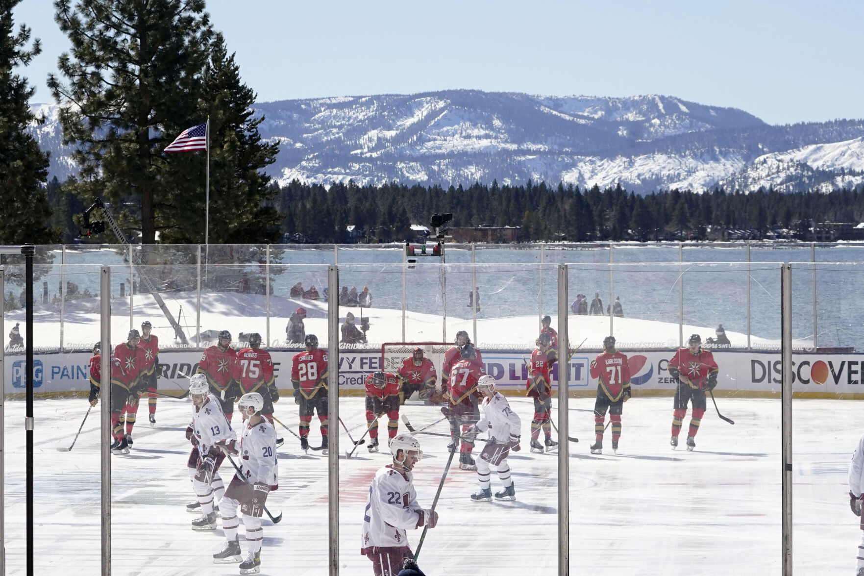 Members of the Colorado Avalanche, in white, and the Vegas Golden Knights, red, prepare to face off to start the first period of the Outdoor Lake Tahoe NHL hockey game in Stateline, Nev., Saturday, Feb. 20, 2021. (AP Photo/Rich Pedroncelli) (Rich Pedroncelli)