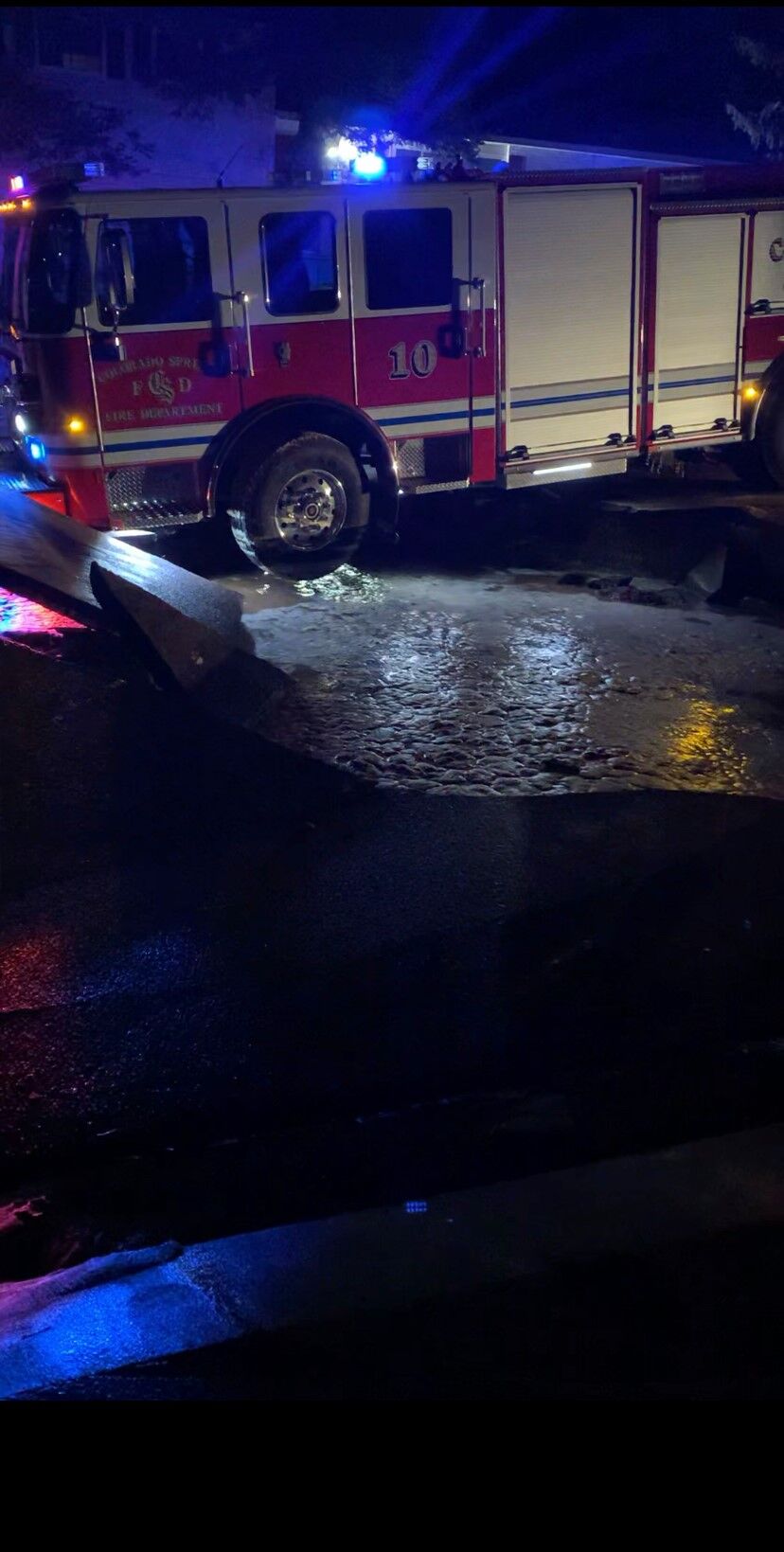 The front bumper of the Colorado Springs Fire Department's newest engine halted its fall into a sinkhole early Sunday, preventing what could have been serious damage to a $521,000 vehicle added to the department's fleet three weeks earlier. (Photo courtesy of Courtesy of Colorado Springs Fire Department.) (Courtesy of Colorado Springs Fire Department)