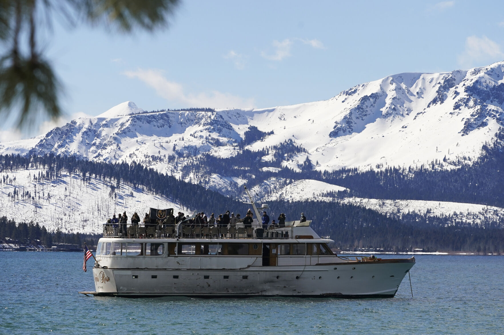 A flag of the Vegas Golden Knights is displayed on a boat floating on Lake Tahoe off shore of the temporary ice rink where the Golden Knights will play the Colorado Avalanche in an NHL hockey game at Stateline, Nev., Saturday, Feb. 20, 2021. (Rich Pedroncelli - staff, AP)