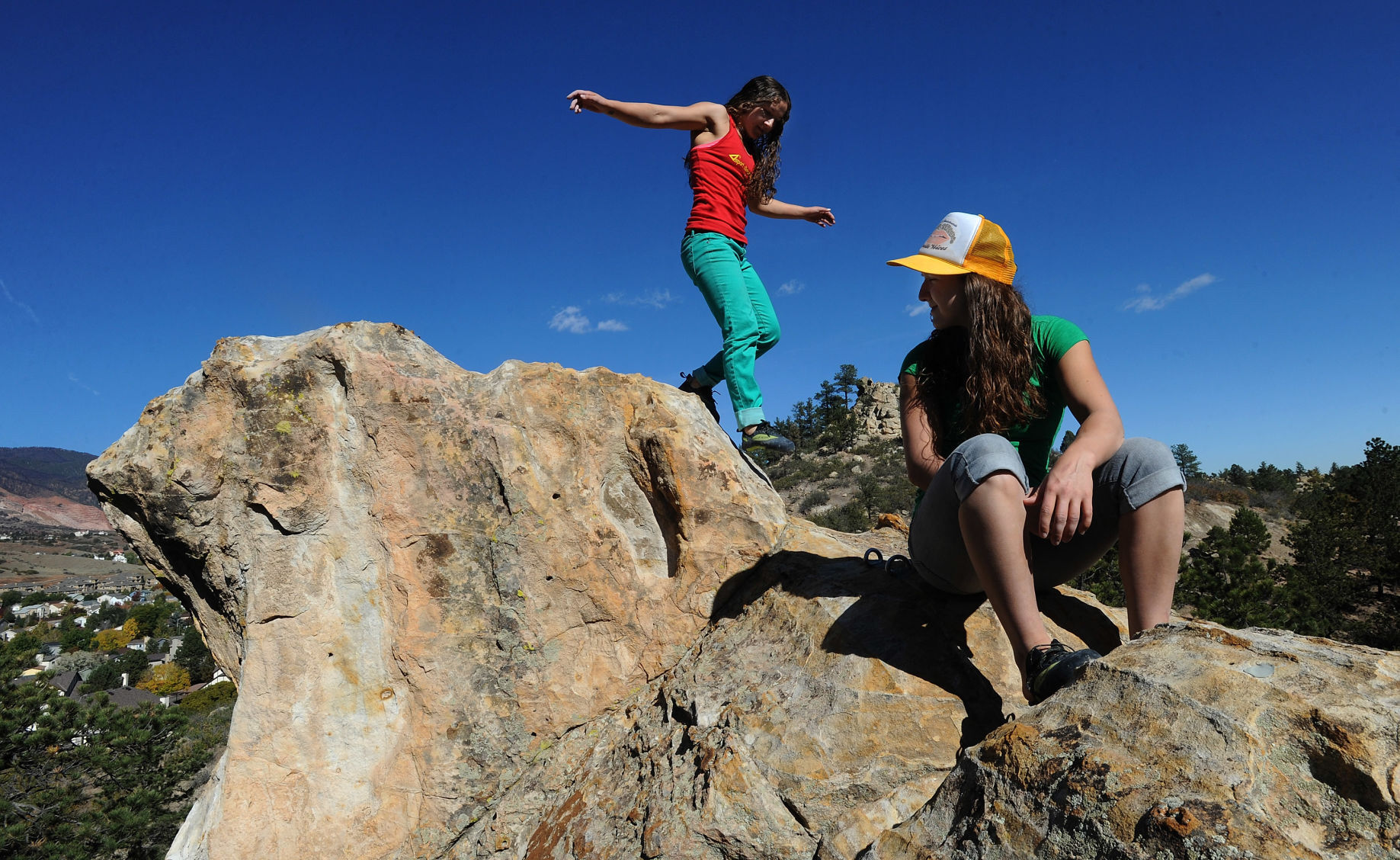 Tyler, front, and Jesse Young-werth scramble on the cliffs in Ute Valley Park in 2012, just months after the nationally ranked rock climbers each had two brain surgeries.