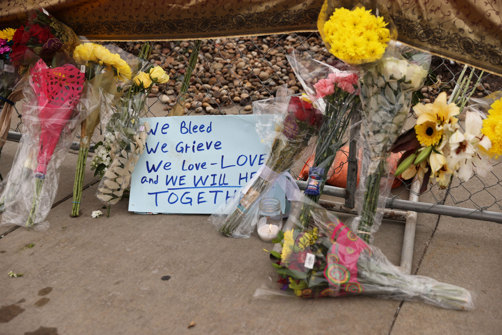 Flowers, cards and candles adorn a makeshift memorial outside of the King Soopers on Table Mesa Drive in Boulder on March 23, 2021. A gunman killed 10 people in a mass shooting at the store the day before. (Forrest Czarnecki/The Gazette) (Forrest Czarnecki)