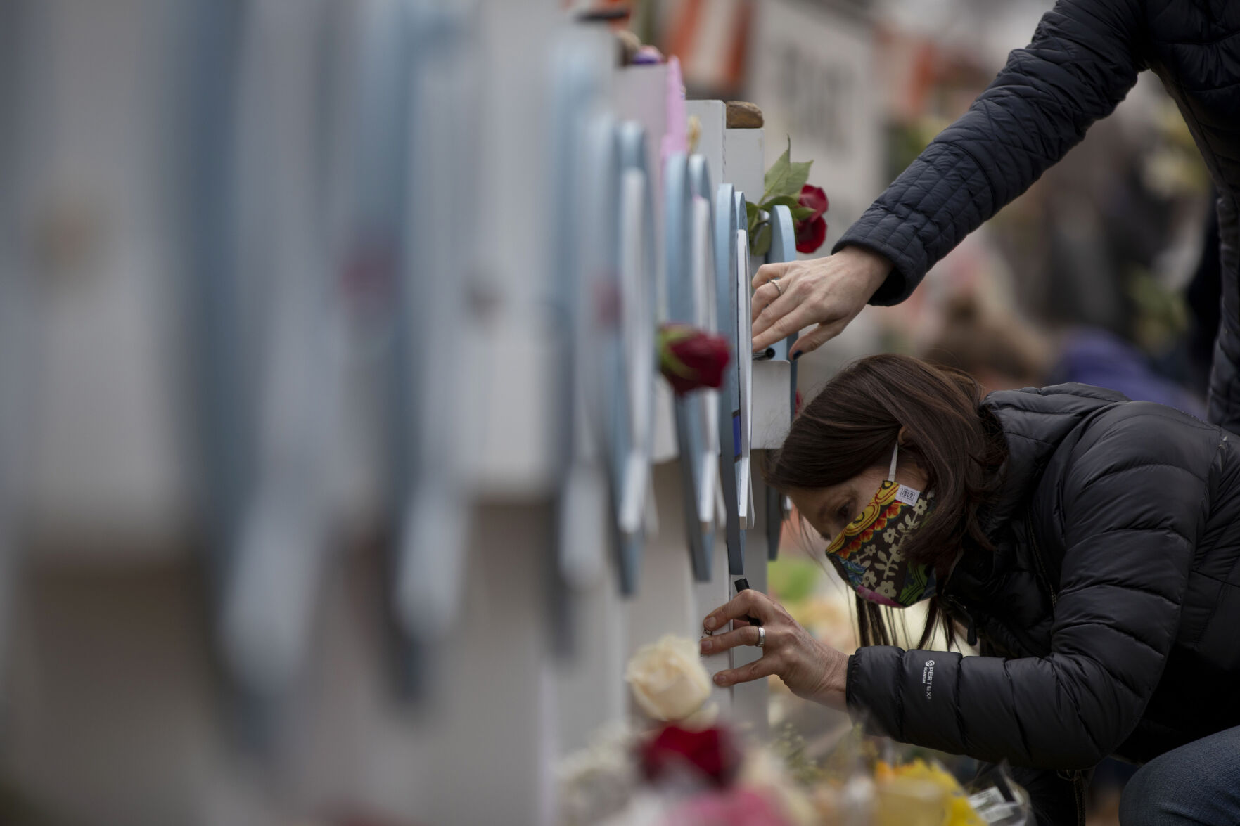 Scenes from the memorial that sprang up on the fence in front the of the King Soopers on Table Mesa in Boulder. (Chancey Bush, The Denver Gazette)