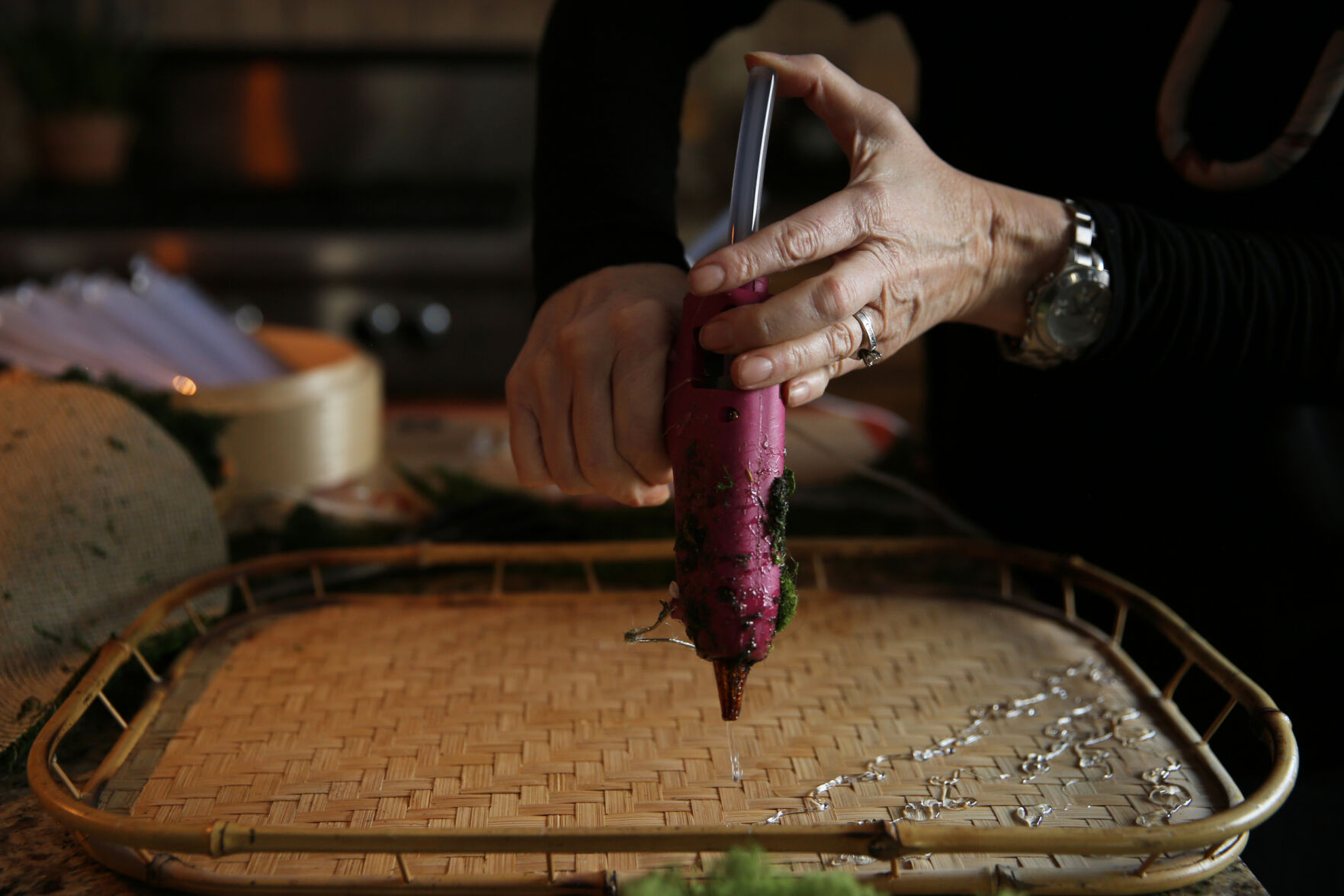 Courtney Arnstein applies hot glue to the backing of a new art piece while working at her home in Colorado Springs on Feb. 12, 2021. (Forrest Czarnecki/The Gazette)