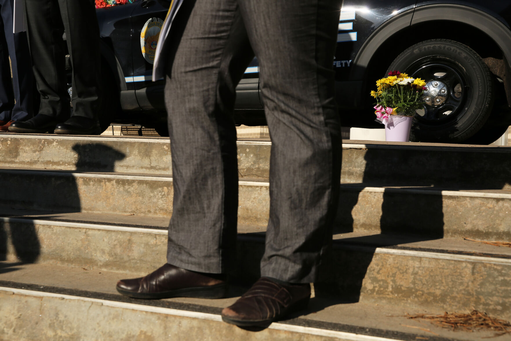 Flowers honoring Eric Talley sit in front of a police car at the Boulder Police Department headquarters on March 23, 2021. A gunman killed 10 people, including Boulder police officer Talley, in a mass shooting at a King Soopers in town the day before. (Forrest Czarnecki/The Gazette) (Forrest Czarnecki)