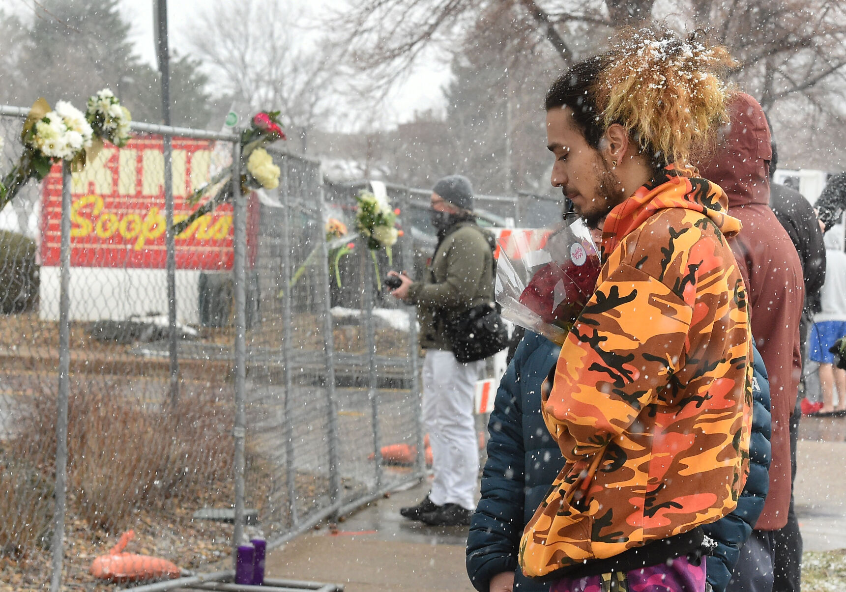 Jared Gallegos had been standing out for nearly an hour, clutching a bouquet of flowers to leave for his childhood friend, Rikki Olds on Tuesday, March 23, 2021. Rikki was shot and killed at the Boulder King Soopers on Monday. (Photo by Jerilee Bennett, The Gazette) (JERILEE BENNETT)