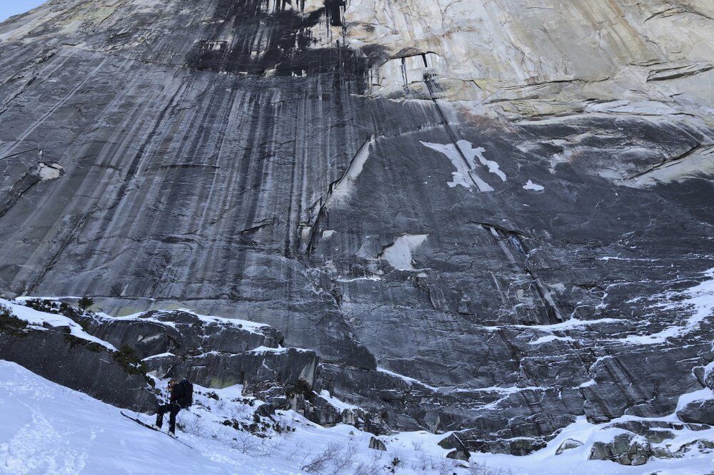 In this photo provided by Jason Torlano, Zach Milligan, lower left, makes his descent down Half Dome in Yosemite National Park, Calif., on Sunday, Feb. 21, 2021. Two men climbed some 4,000 feet to the top of Yosemite's Half Dome in subfreezing temperatures and skied down the famously steep monolith to the valley floor. Jason Torlano, 45, and Zach Milligan, 40, completed the daring descent in five hours on Sunday by charging down Half Dome's arching back and using ropes to rappel down several sections of bare rock known as the 