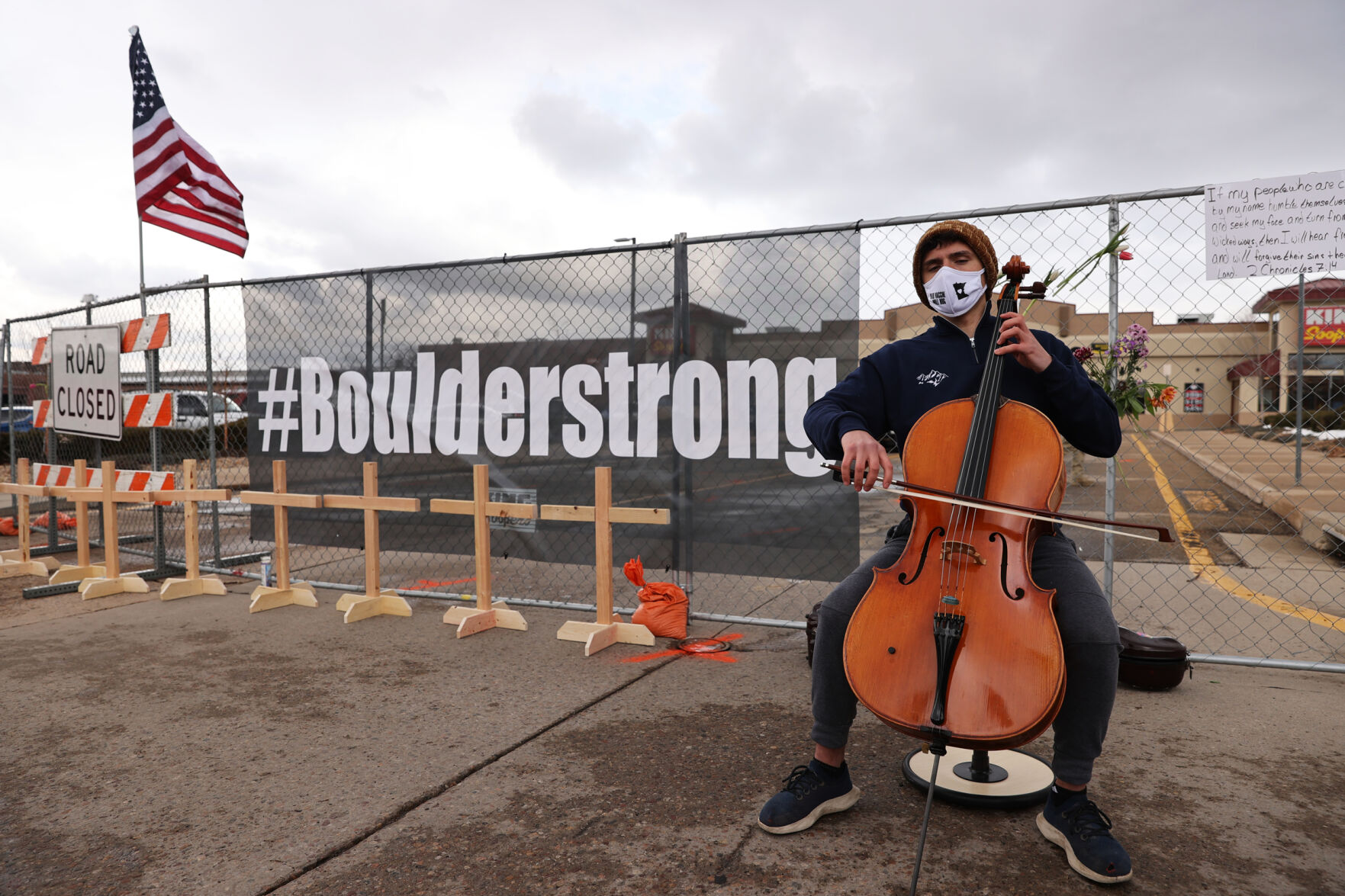 A cellist plays in front of the memorial outside the King Soopers on Table Mesa Drive in Boulder on March 23, 2021. A gunman killed 10 people in a mass shooting at the store the day before. (Forrest Czarnecki/The Gazette) (Forrest Czarnecki)