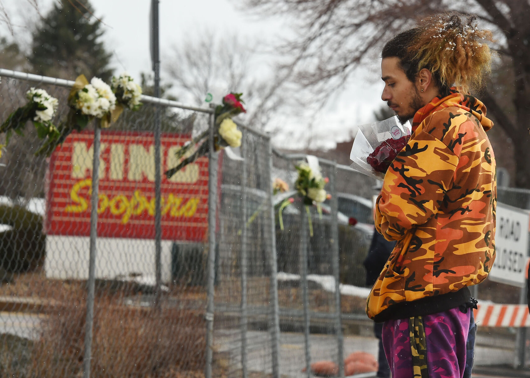 Jared Gallegos had been standing out for nearly an hour, clutching a bouquet of flowers to leave for his childhood friend, Rikki Olds on Tuesday, March 23, 2021. Rikki was shot and killed at the Boulder King Soopers on Monday. (Photo by Jerilee Bennett, The Gazette) (JERILEE BENNETT)