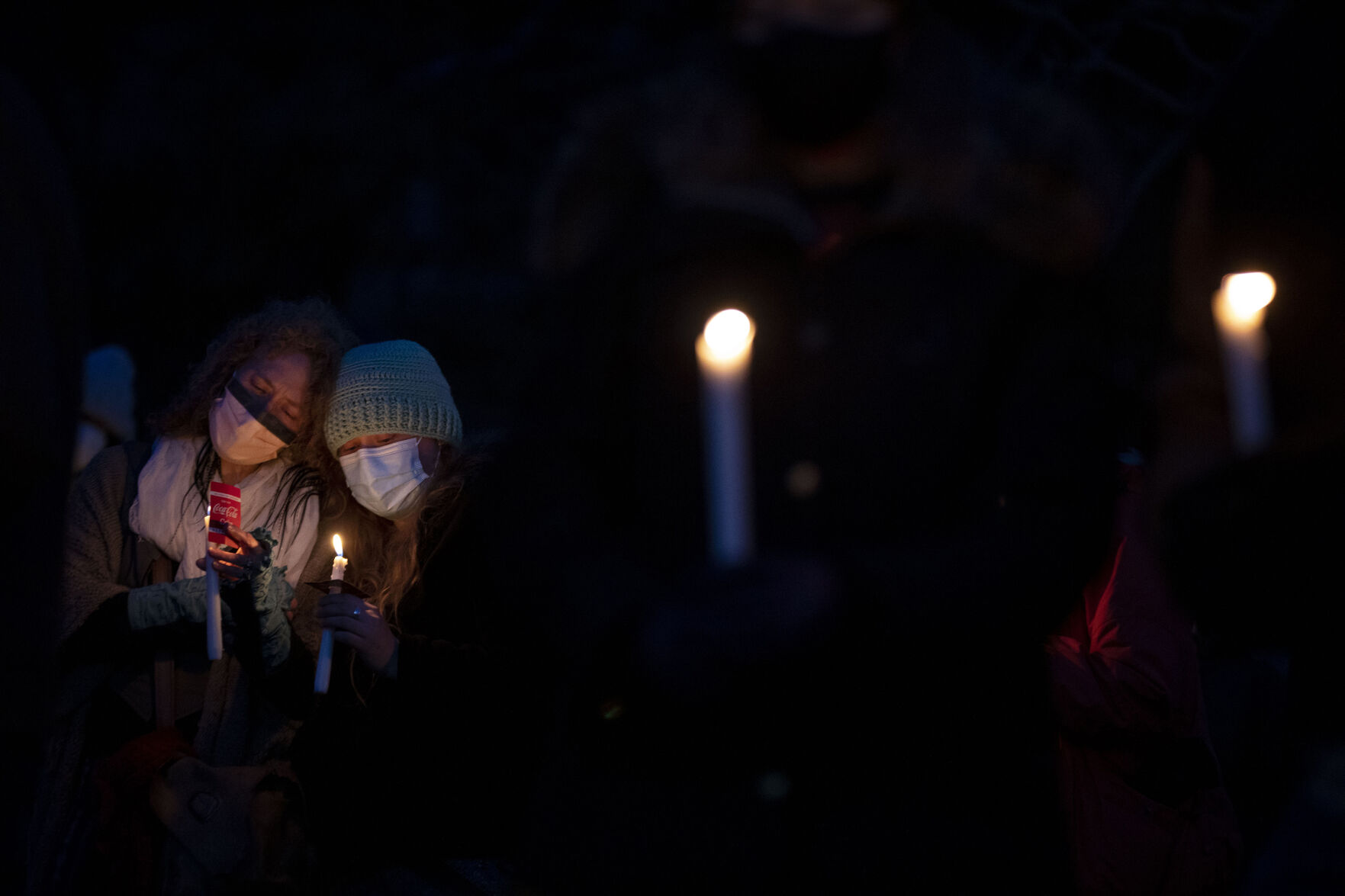 Jill Ascher and her daughter Maddie Lutz comfort each other during a candlelight vigil to mourn the loss of 10 people including a police officer who were killed in a mass shooting at King Soopers supermarket on Monday, outside the courthouse in Boulder, Colo., on Wednesday, March 24, 2021. Ascher lost her friend Tralona “Lonna” Bartkowiak. (Chancey Bush/ The Gazette) (Chancey Bush)