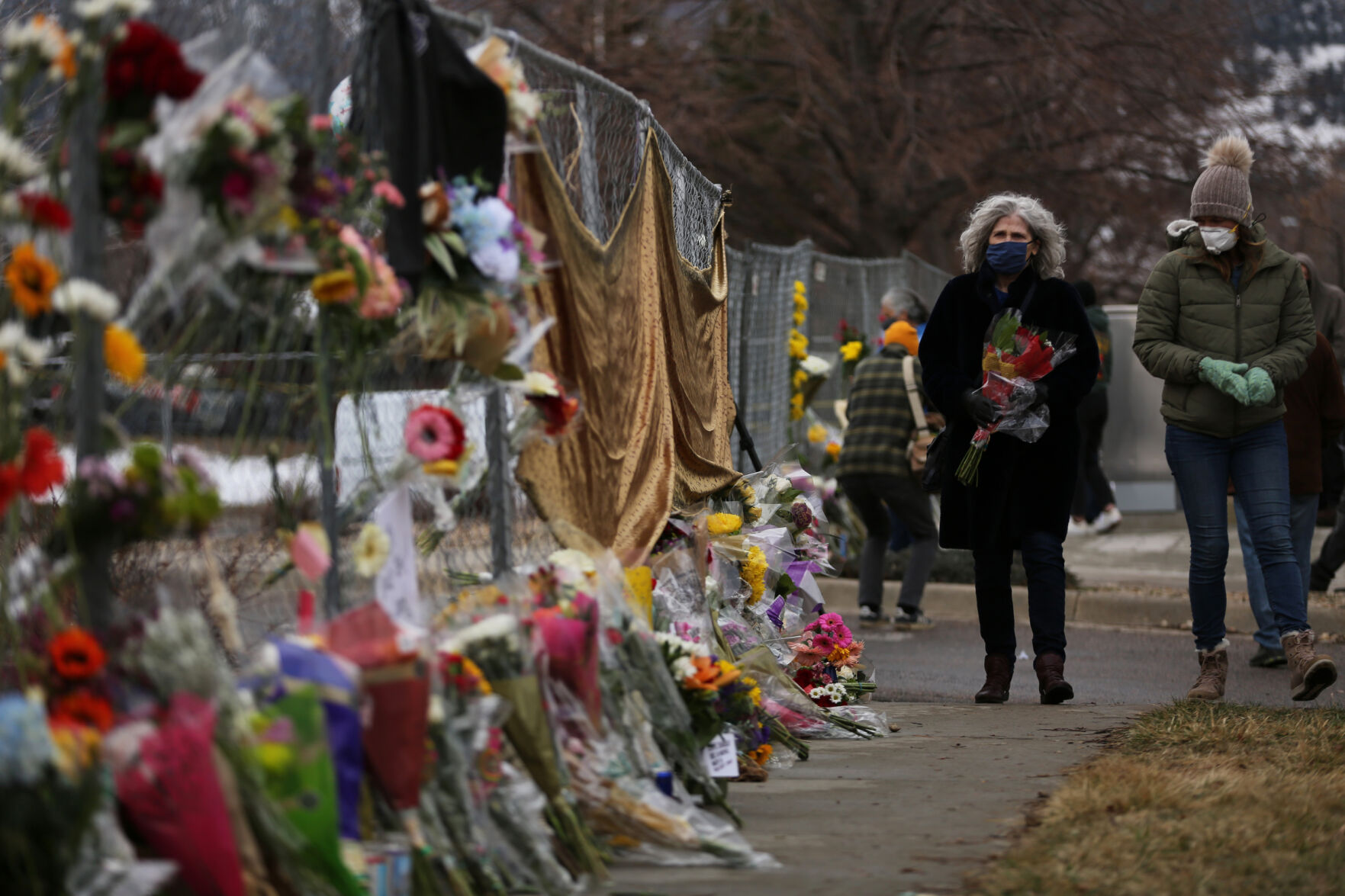 Community members bring flowers and make their contribution to the makeshift memorial outside the King Soopers on Table Mesa Drive in Boulder on March 23, 2021. A gunman killed 10 people in a mass shooting at the store the day before. (Forrest Czarnecki/The Gazette) (Forrest Czarnecki)
