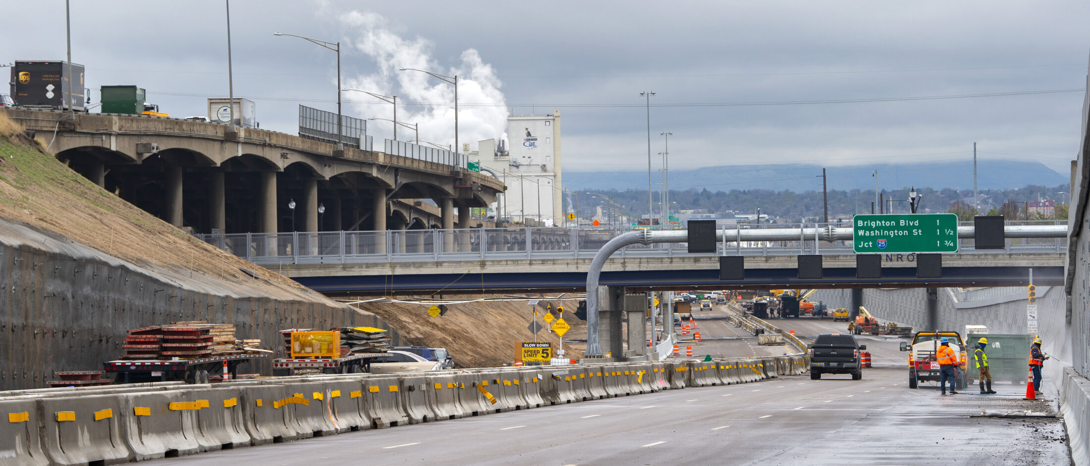 Crews work on the new lanes of the Central 70 Project between Colorado and Brighton boulevards in Denver as traffic drives above on the remaining viaduct Tuesday, May 11, 2021. The freeway will be closed between Washington Street and Interstate 270 beginning 5 a.m. Friday, May 21, 2021, to move traffic off the 57-year-old viaduct and onto the new lanes. Both directions of traffic will travel on the lower section beginning the following Monday as part of the MIle High Shift. The demolition of old viaduct will then begin afterward with the highway projected to be finished in the fall of 2022. (The Gazette, Christian Murdock) (Christian Murdock/The Gazette)