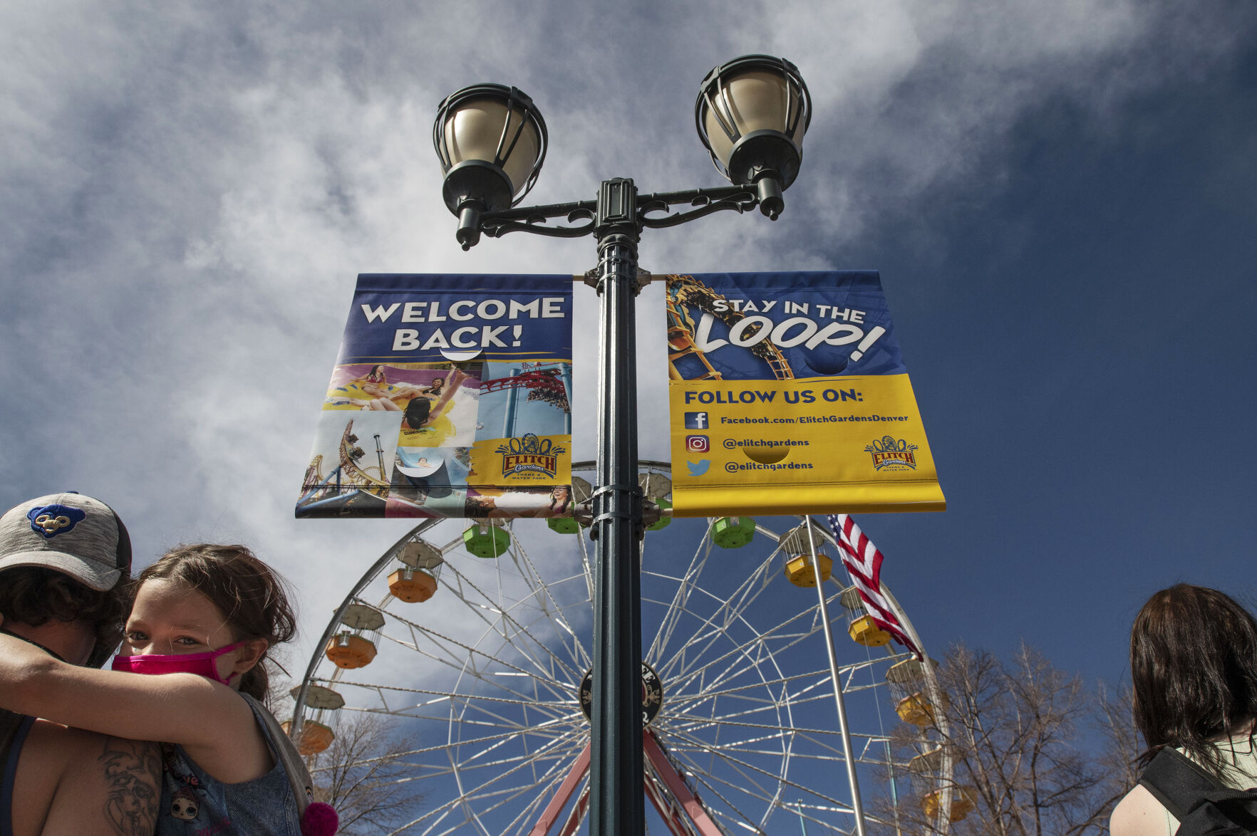 Bill Melka holds his daughter Keira Melka, 6, as they wait for the rides to open during opening day at Elitch Gardens in Denver, Colo., on Saturday, May 1, 2021. The amusement park opened for the first time since Nov. 3, 2019, at 43% of their normal capacity without the water park. (Chancey Bush/ The Gazette) (Chancey Bush/ The Gazette)