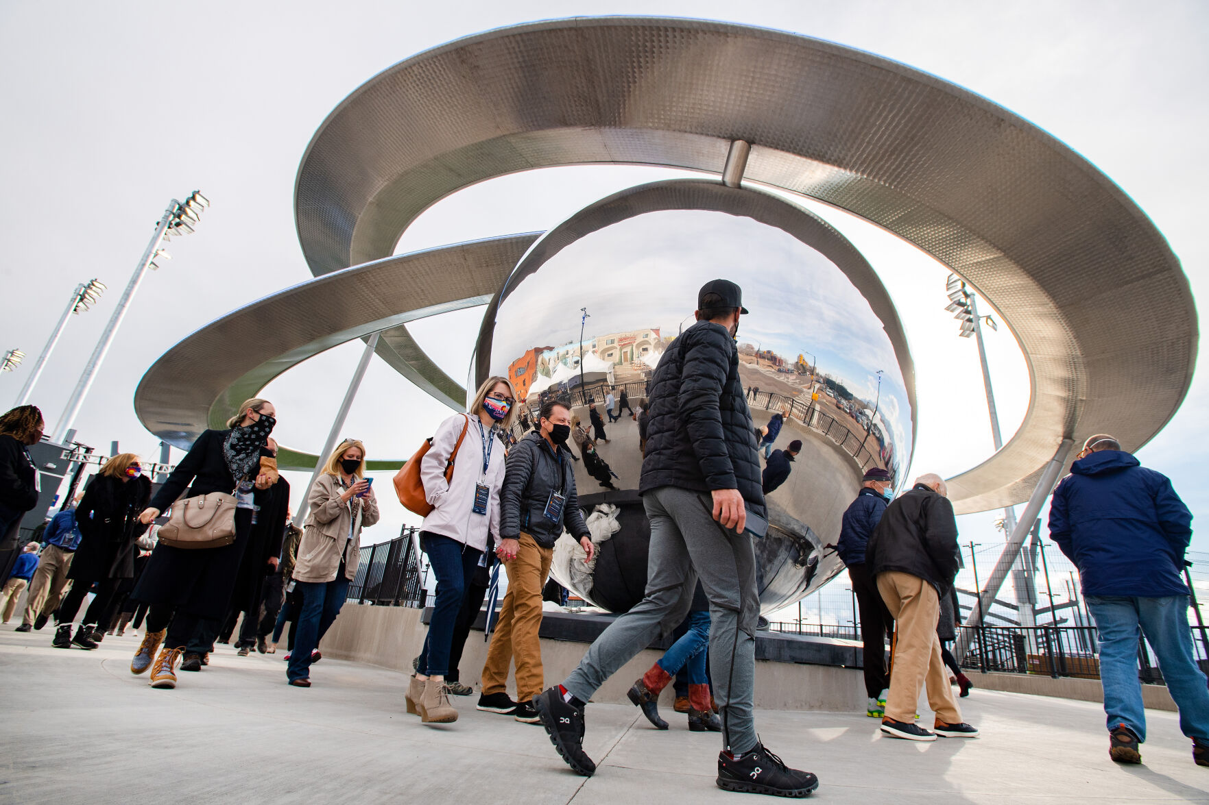 People walk past the 35-foot tall, 65-foot diameter “Epicenter” sculpture as they enter the new Weidner Field Friday night, April 23, 2021. The $4.5 million sculpture at the entrance to the soccer stadium was reveal to an invited crowd during a tour of the new facility. The Switchbacks play their first match at the stadium Saturday in a preseason game against Orange County. (The Gazette, Christian Murdock) (Christian Murdock/The Gazette)