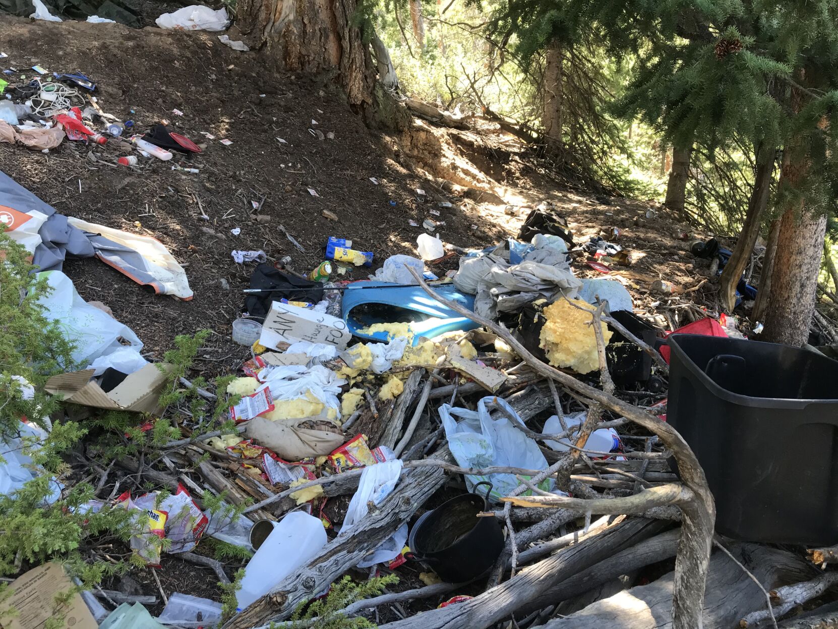 Piles of trash left by dispersed campers in the woods of the Dillon Ranger District in Summit County. Photo courtesy U.S. Forest Service