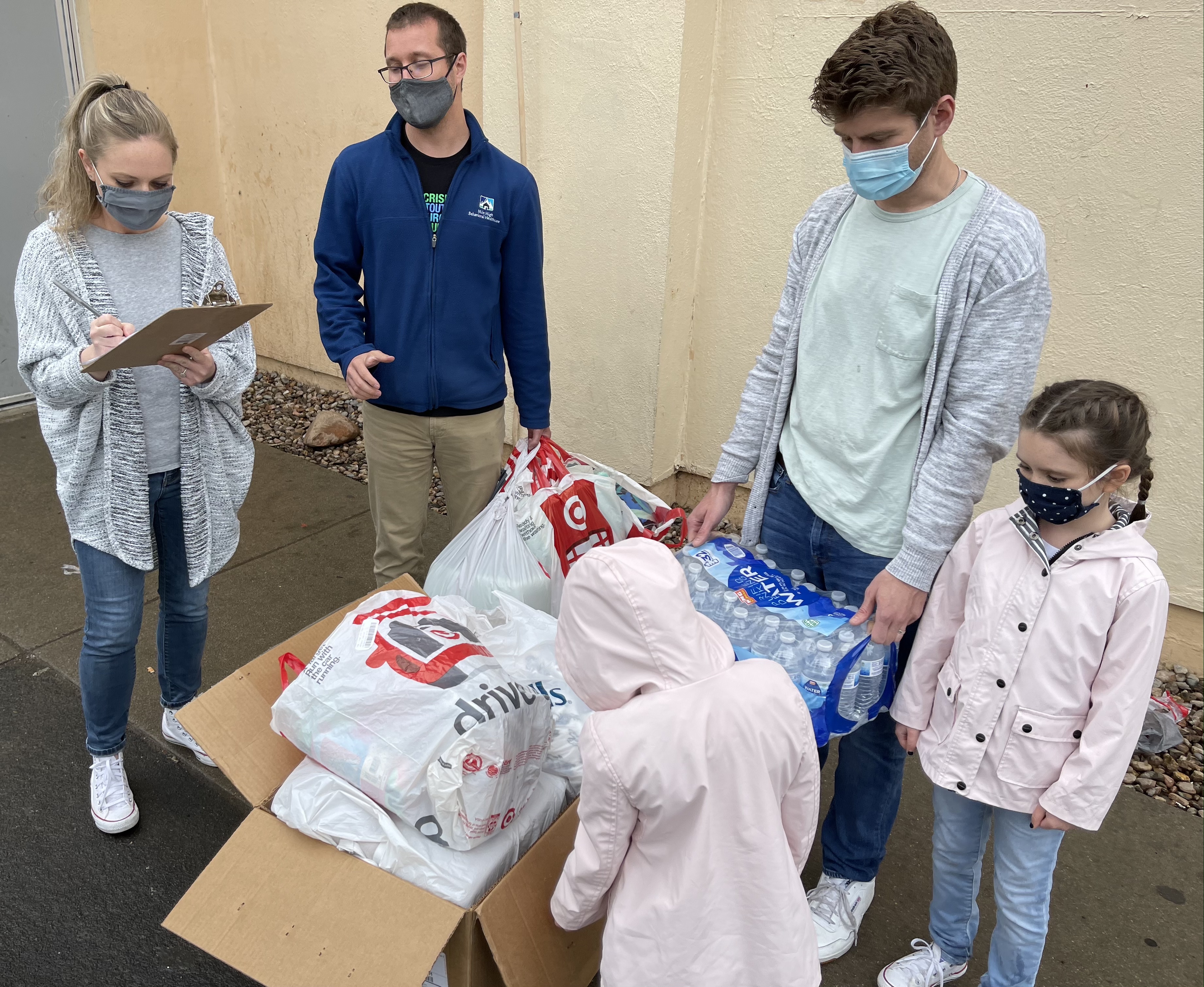 Grey, Nora, Tierney and Joshua Giannotti making their donation at the Aurora Day Resource Center during 