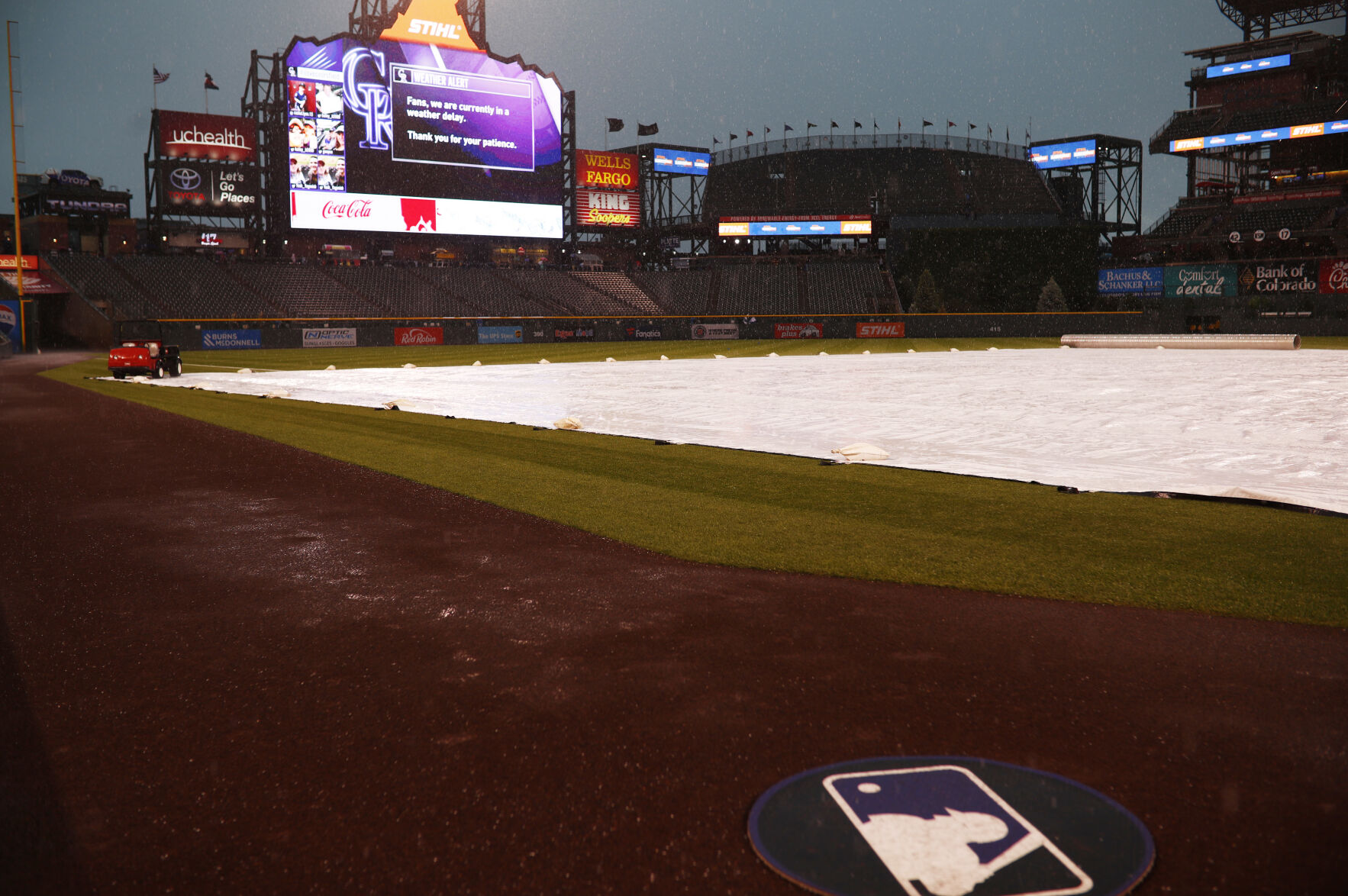 Rain falls on the covered field as a storm sweeps over Coors Field to postpone a baseball game between the San Francisco Giants and the Colorado Rockies, Monday, May 28, 2018, in Denver. (AP Photo/David Zalubowski) (David Zalubowski)