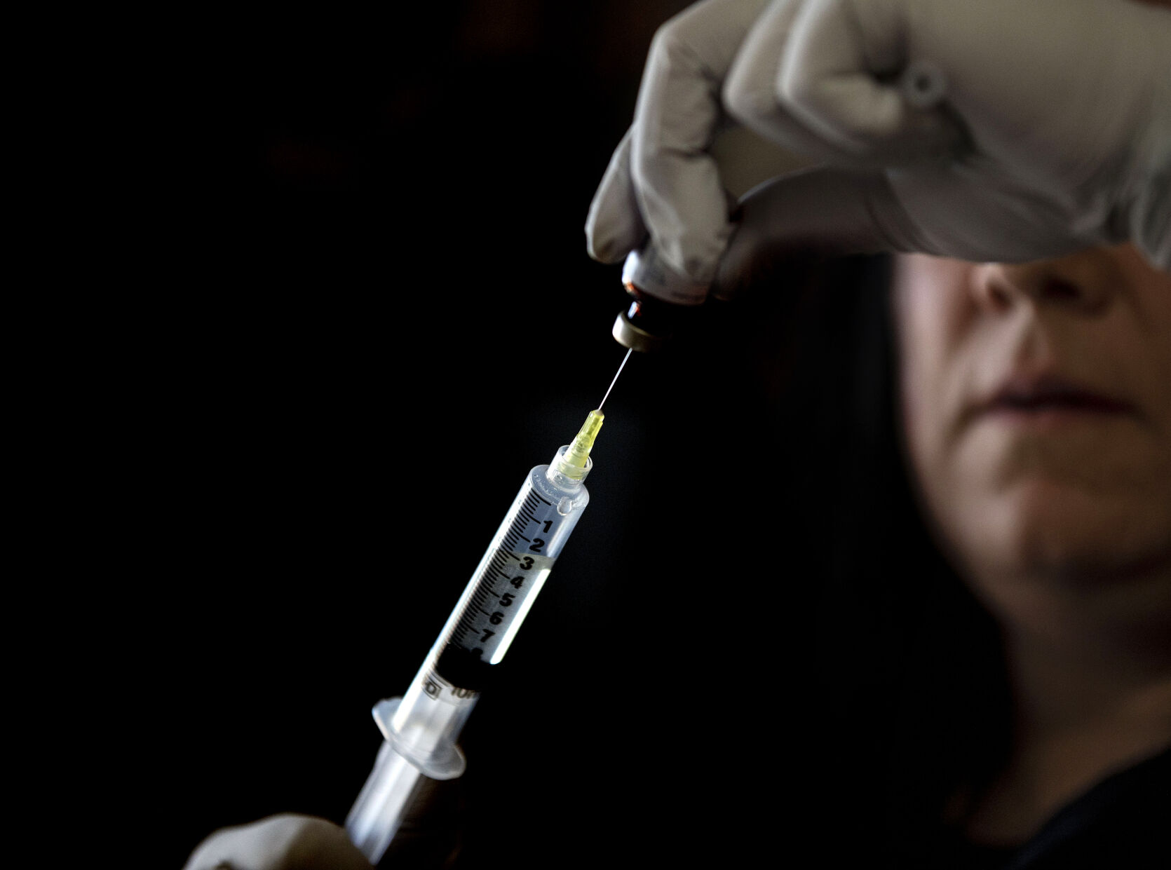 Brenna Logan, 37, helps her older sister Kendra Lippy, 38, change her TPN bag, at Lippy’s home in Colorado Springs on May 19, 2021. Logan helps her sister change her TPN bag every evening. The bag delivers nutrients to Lippy intravenously. (Chancey Bush/ The Gazette) (Chancey Bush/ The Gazette)