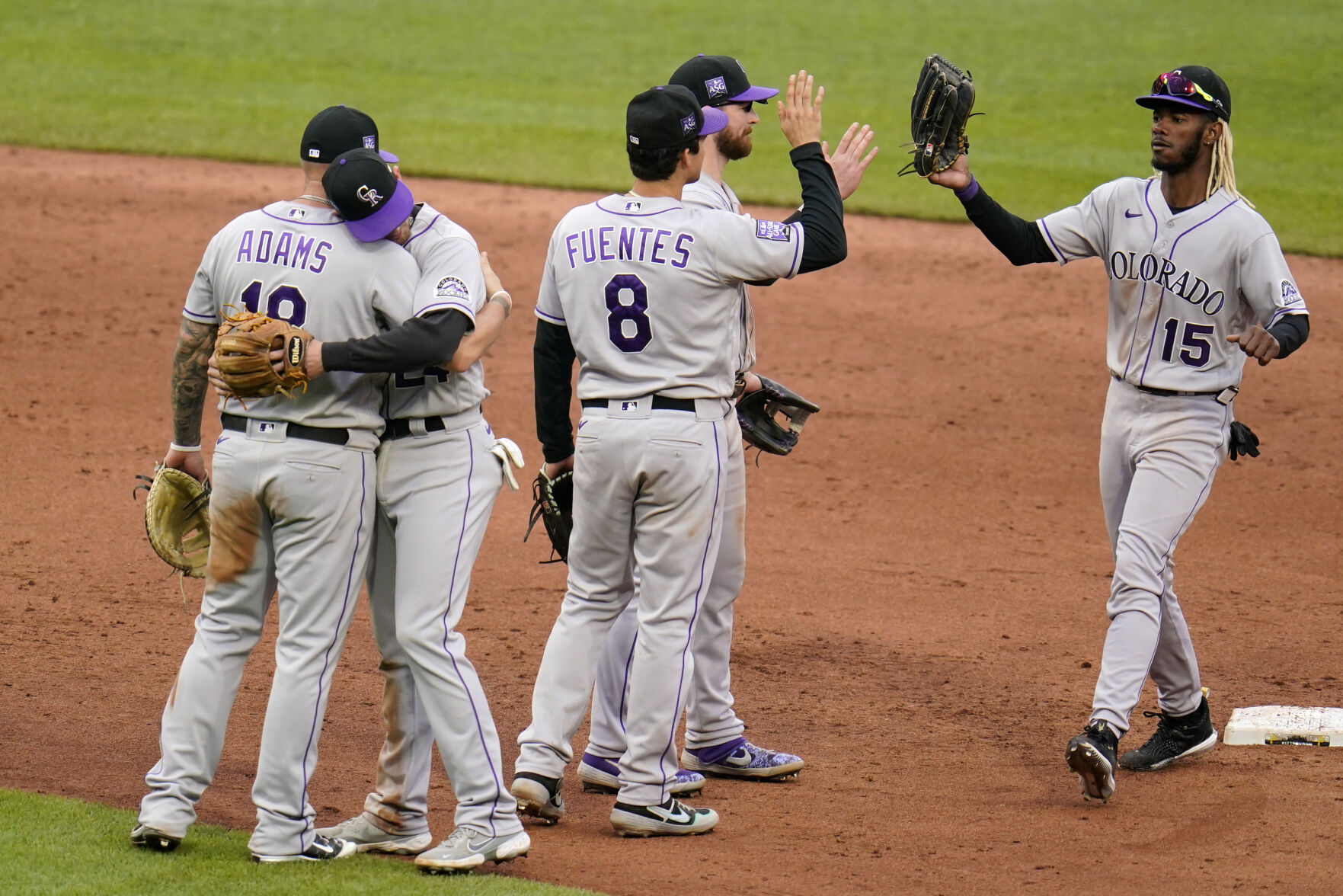 Colorado Rockies Matt Adams, left, and Ryan McMahon embrace as they celebrate after getting the final out of a win over the Pittsburgh Pirates in a baseball game in Pittsburgh, Sunday, May 30, 2021. (AP Photo/Gene J. Puskar) (Gene J. Puskar)