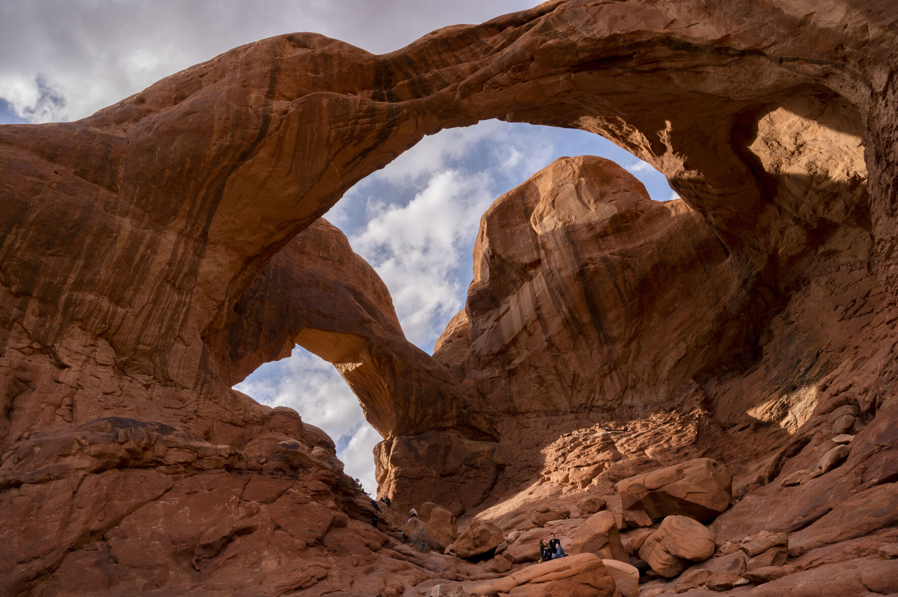 Hikers explore the Double Arches Saturday, March 20, 2021, in Arches National Park outside Moab, Utah. (The Gazette, Christian Murdock) (Christian Murdock/The Gazette)