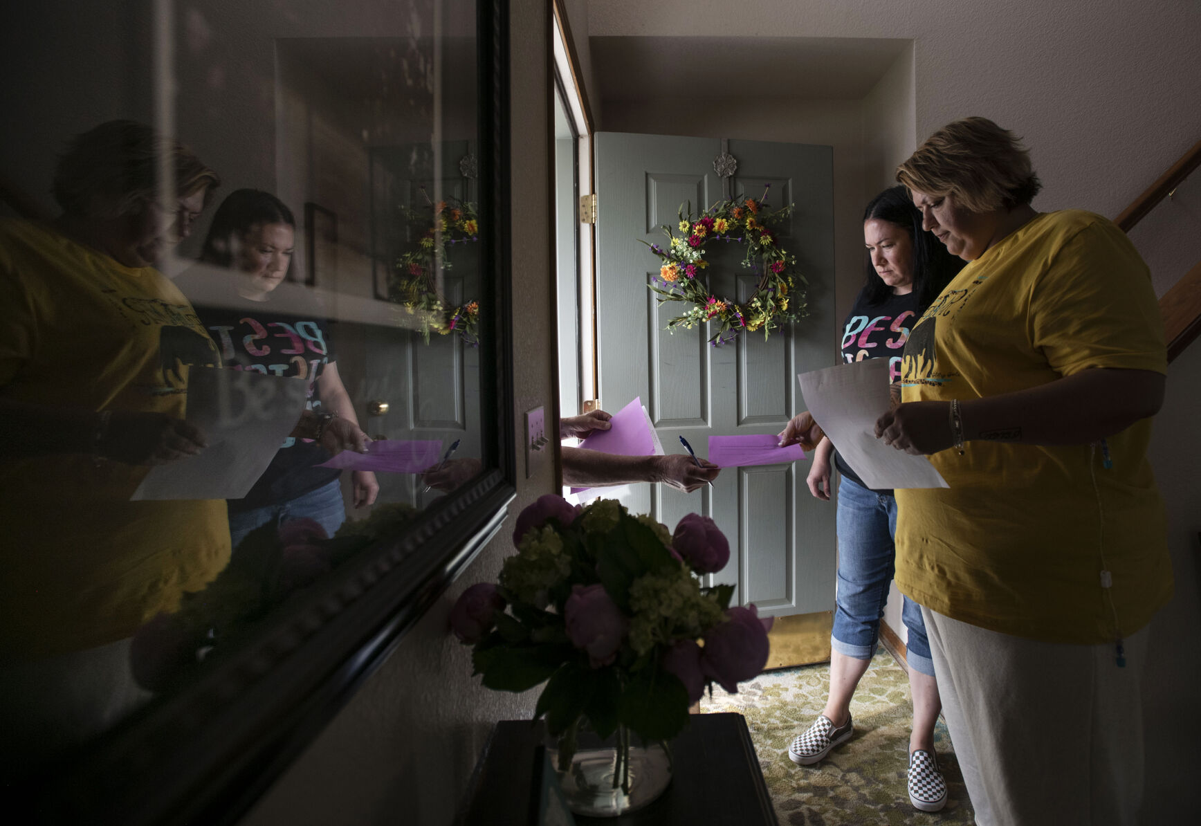 Sisters Brenna Logan, 37, and Kendra Lippy, 38, receive an order for Lippy’s TPN bags at Lippy’s home in Colorado Springs on May 19, 2021. Logan helps her sister change her TPN bag every evening. The bag helps provide nutrients intravenously. (Chancey Bush/ The Gazette) (Chancey Bush/ The Gazette)