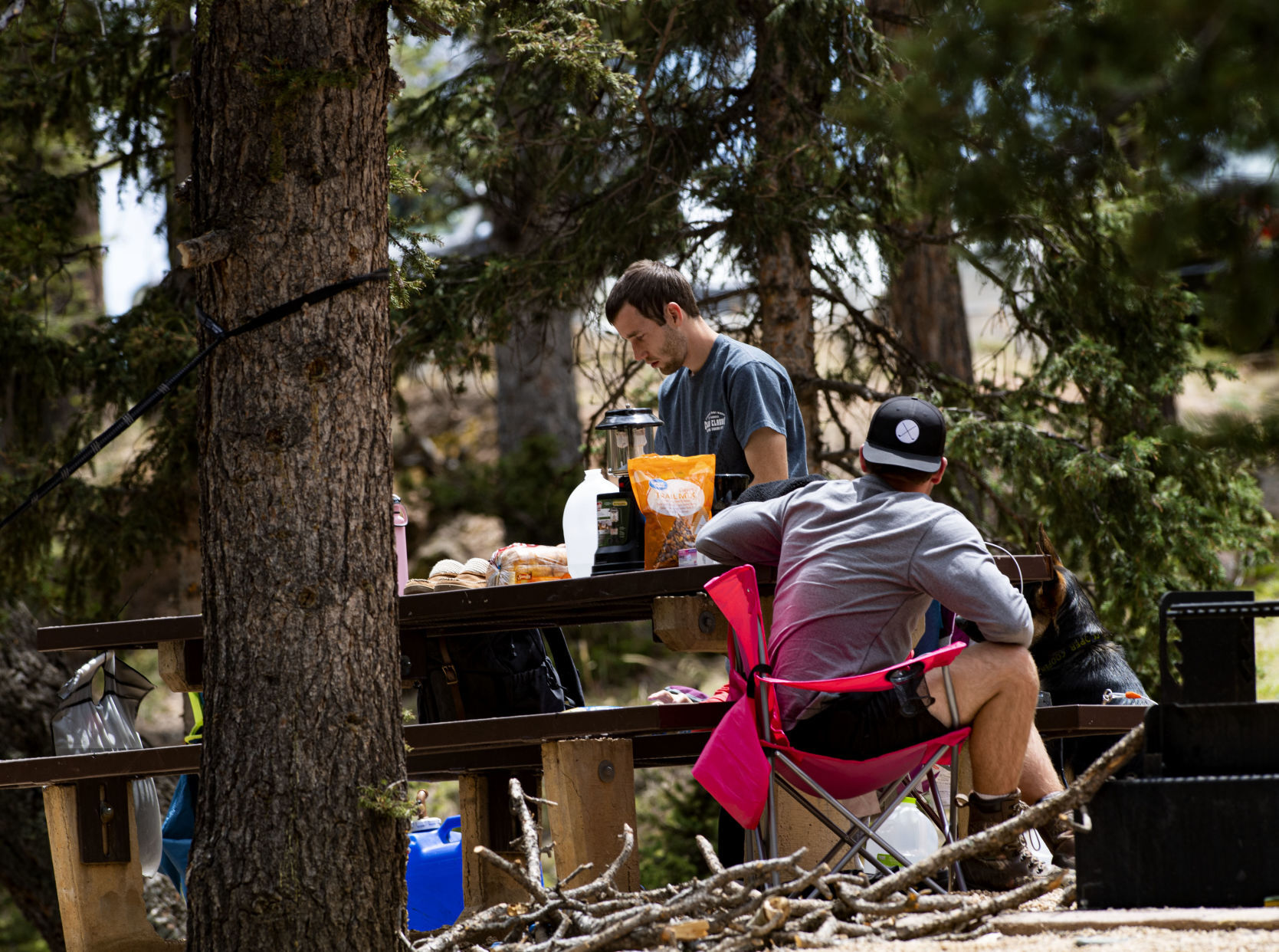 Brandon Ladd, standing, and Austin Hatch from Kansas City, Mo., relax at their campsite in Mueller State Park Thursday, May 14, 2020. The state park opened Tuesday to reservations only after being closed since March 26, 2020, because of the COVID-19 pandemic. The campground is sold out for this weekend. (The Gazette, Christian Murdock)