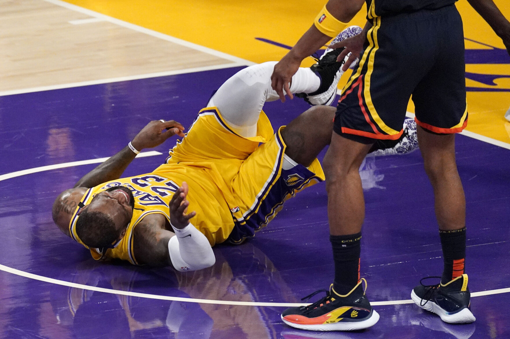 Los Angeles Lakers forward LeBron James hits the floor after being fouled while shooting by Golden State Warriors forward Draymond Green during the second half of an NBA Western Conference Play-In game Wednesday, May 19, 2021, in Los Angeles. (AP Photo/Mark J. Terrill) (Mark J. Terrill)