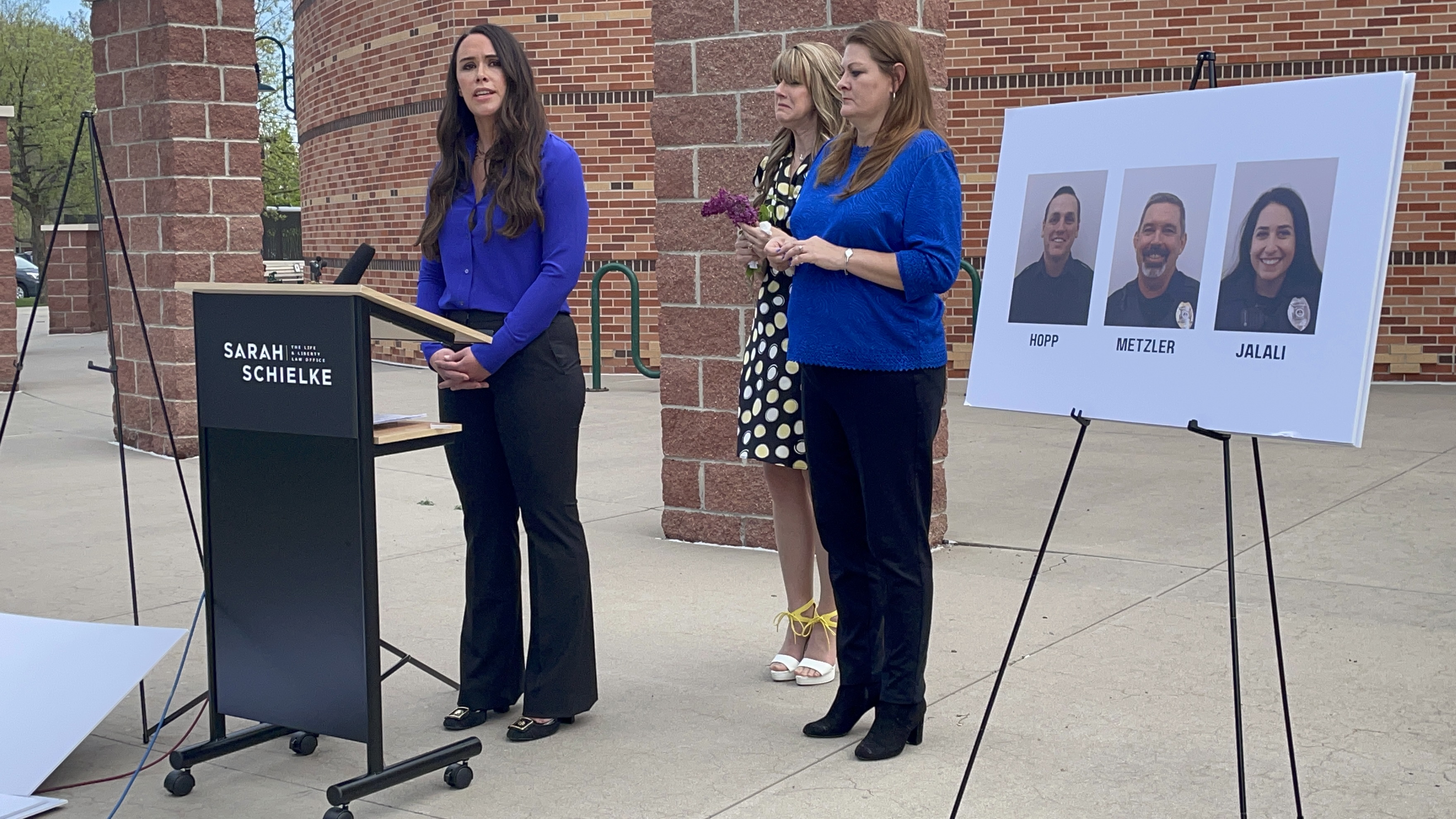 Attorney Sarah Schielke speaks during a news conference on May 19, 2021 outside the Loveland Police Department. She slammed the 8th Judicial District Attorney's decision to file criminal charges against only two Loveland police officers for their use of force during their arrest of Karen Garner, who was 73 at the time and has dementia, last summer. Garner's daughter, Allisa Swartz (center), and daughter-in-law, Shannon Steward (right), joined Schielke at the news conference. (Julia Cardi/The Denver Gazette)