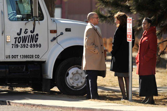 Detra Farries, right, stands with her attorneys next to a J & J Towing truck Tuesday, Feb. 14, as jurors toured the scene at the Park Hill Apartments. Jurors were able to see Farries' SUV and the tow truck in the parking lot of the apartments. Photo by MARK REIS/The Gazette