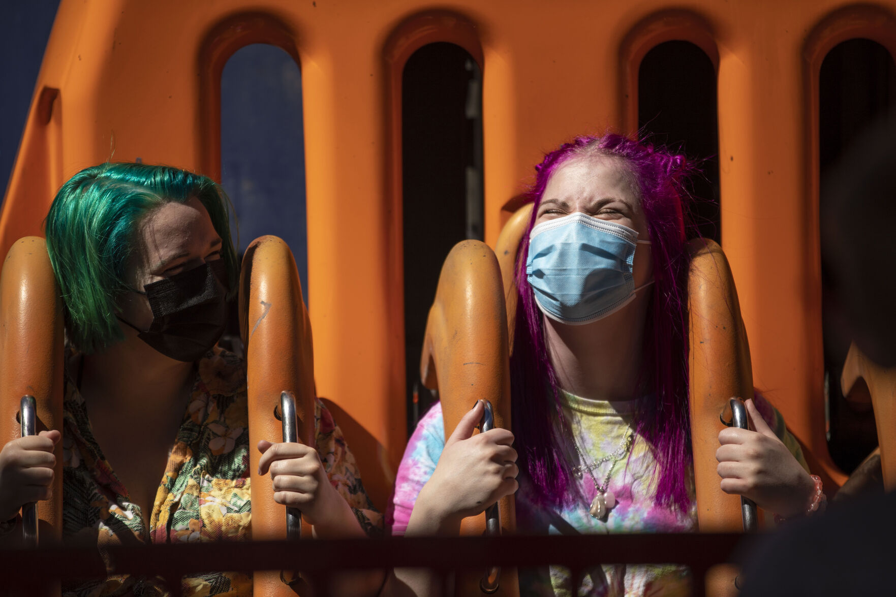 Lily Ritz, left, and Esther Steed, right, prepare to ride The Tower of Doom during opening day at Elitch Gardens in Denver, Colo., on Saturday, May 1, 2021. The amusement park opened for the first time since Nov. 3, 2019, at 43% of their normal capacity without the water park. (Chancey Bush/ The Gazette) (Chancey Bush/ The Gazette)